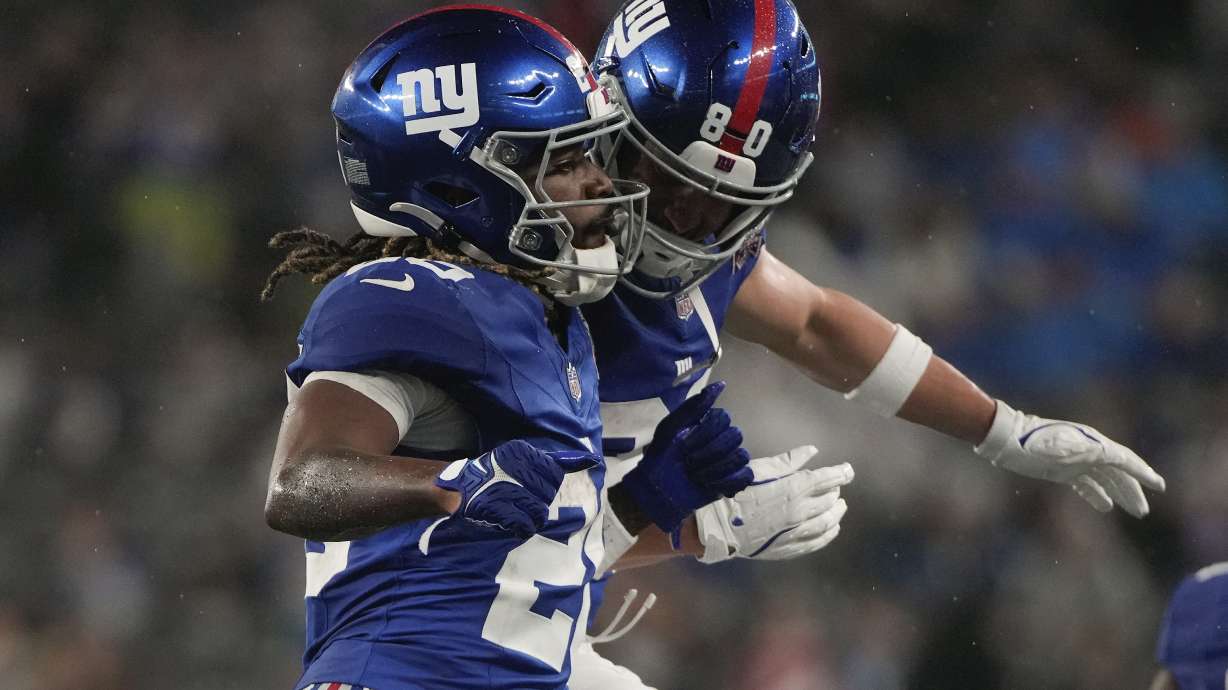 New York Giants running back Eric Gray (20) celebrates with wide receiver Gunner Olszewski (80) after scoring a touchdown against the Detroit Lions during the second quarter of an NFL football game, Thursday, Aug. 8, 2024, in East Rutherford, N.J.
