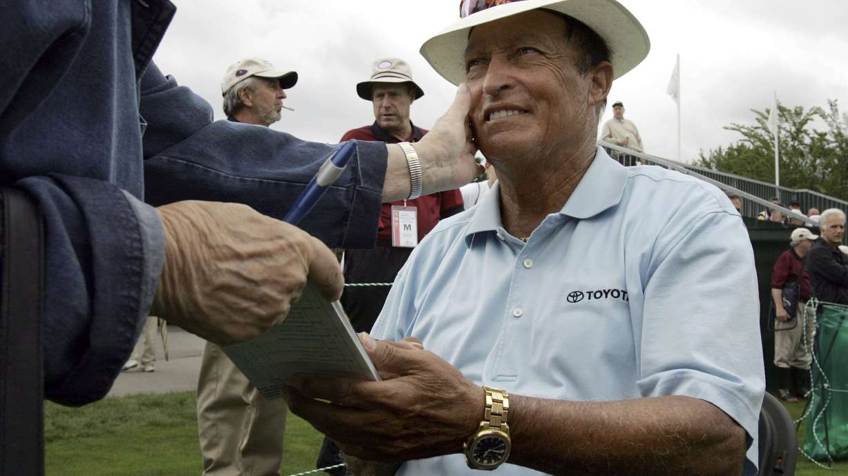 FILE - Chi Chi Rodriguez, of Puerto Rico, smiles while signing an autograph at the Nashawtuc Country Club in Concord, Mass., Friday, June 9, 2006.