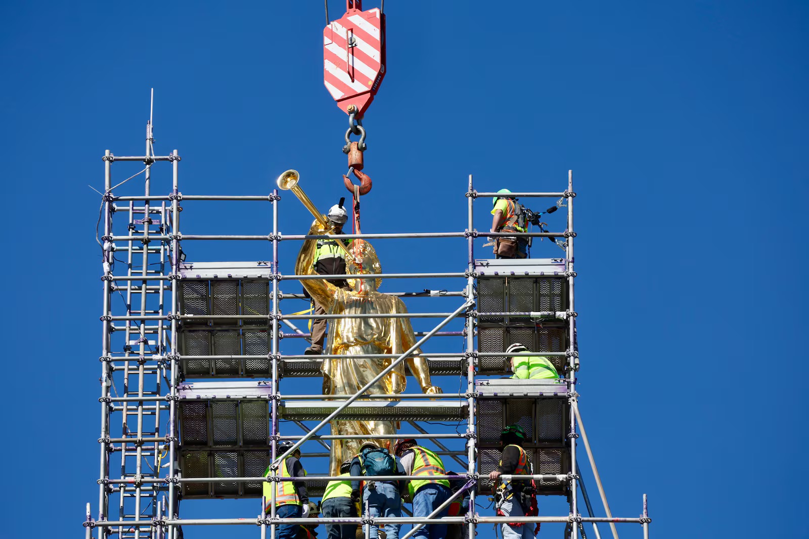 The Angel Moroni statue is lifted into place on the Salt Lake Temple, April 2.