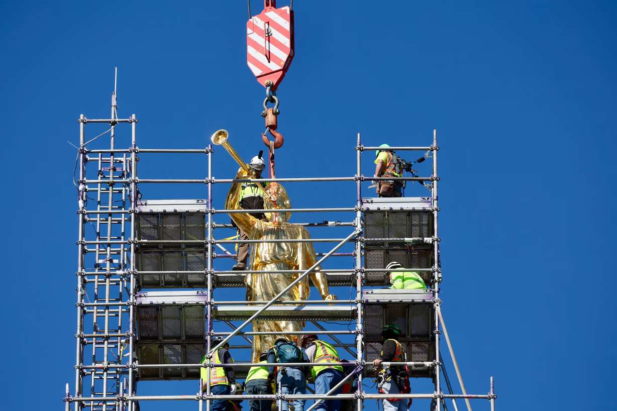 The Angel Moroni statue is lifted into place on the Salt Lake Temple, April 2.