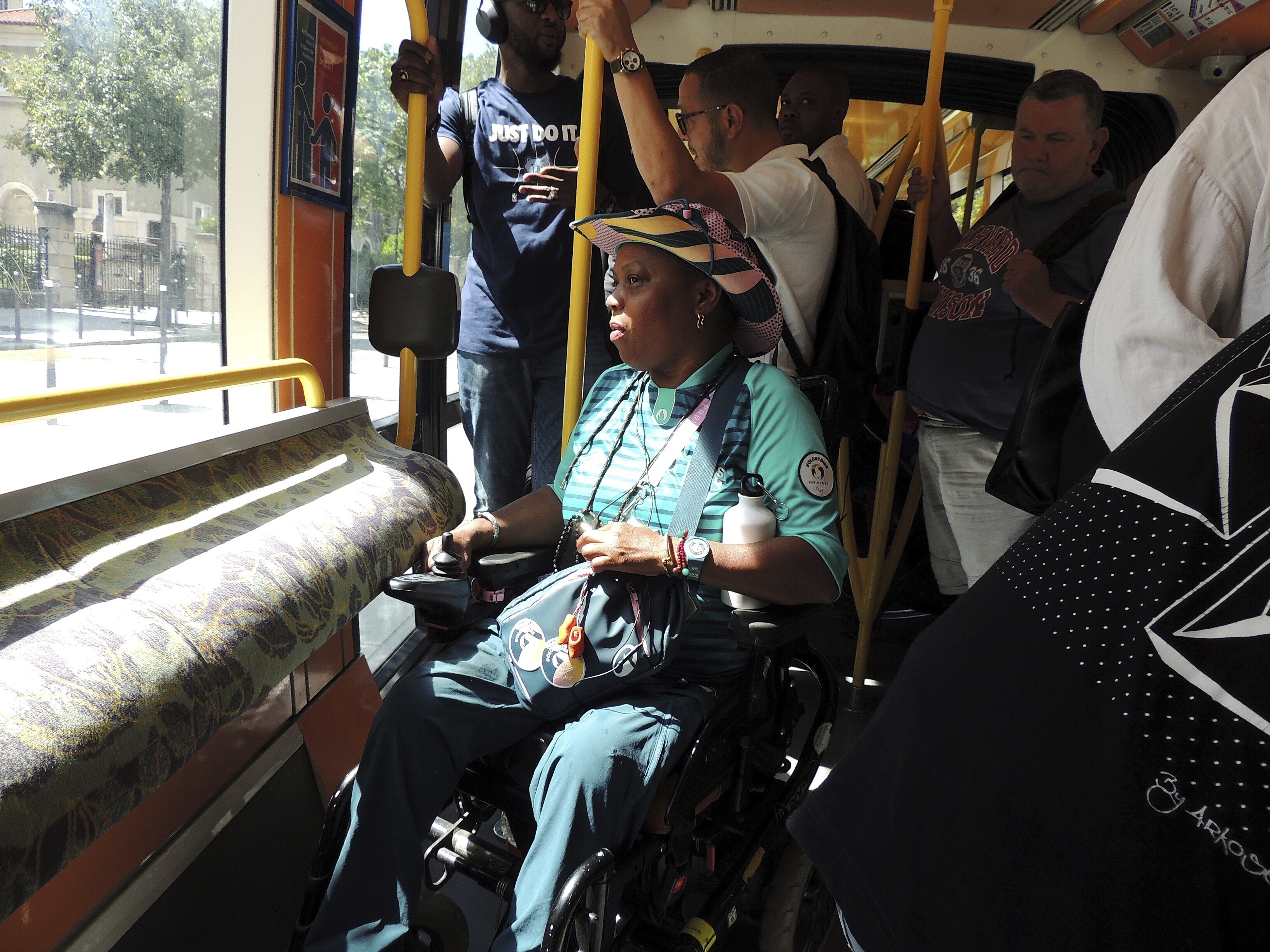 Ndieme Lame, a 57-year-old volunteer for the Paris 2024 Olympic and Paralympic Games, rides on the Tramway T3a line, during the 2024 Summer Olympics, Wednesday, Aug. 7 2024, in Paris, France. 