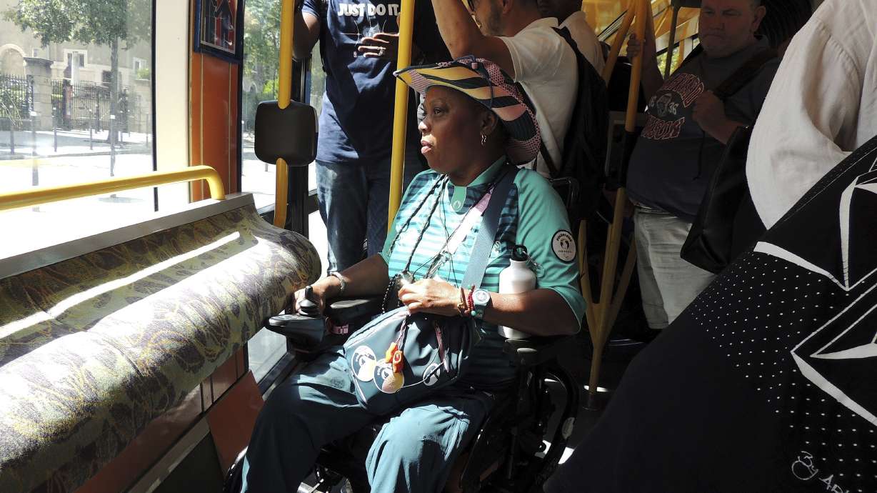 Ndieme Lame, a 57-year-old volunteer for the Paris 2024 Olympic and Paralympic Games, rides on the Tramway T3a line, during the 2024 Summer Olympics, Wednesday, Aug. 7 2024, in Paris, France.
