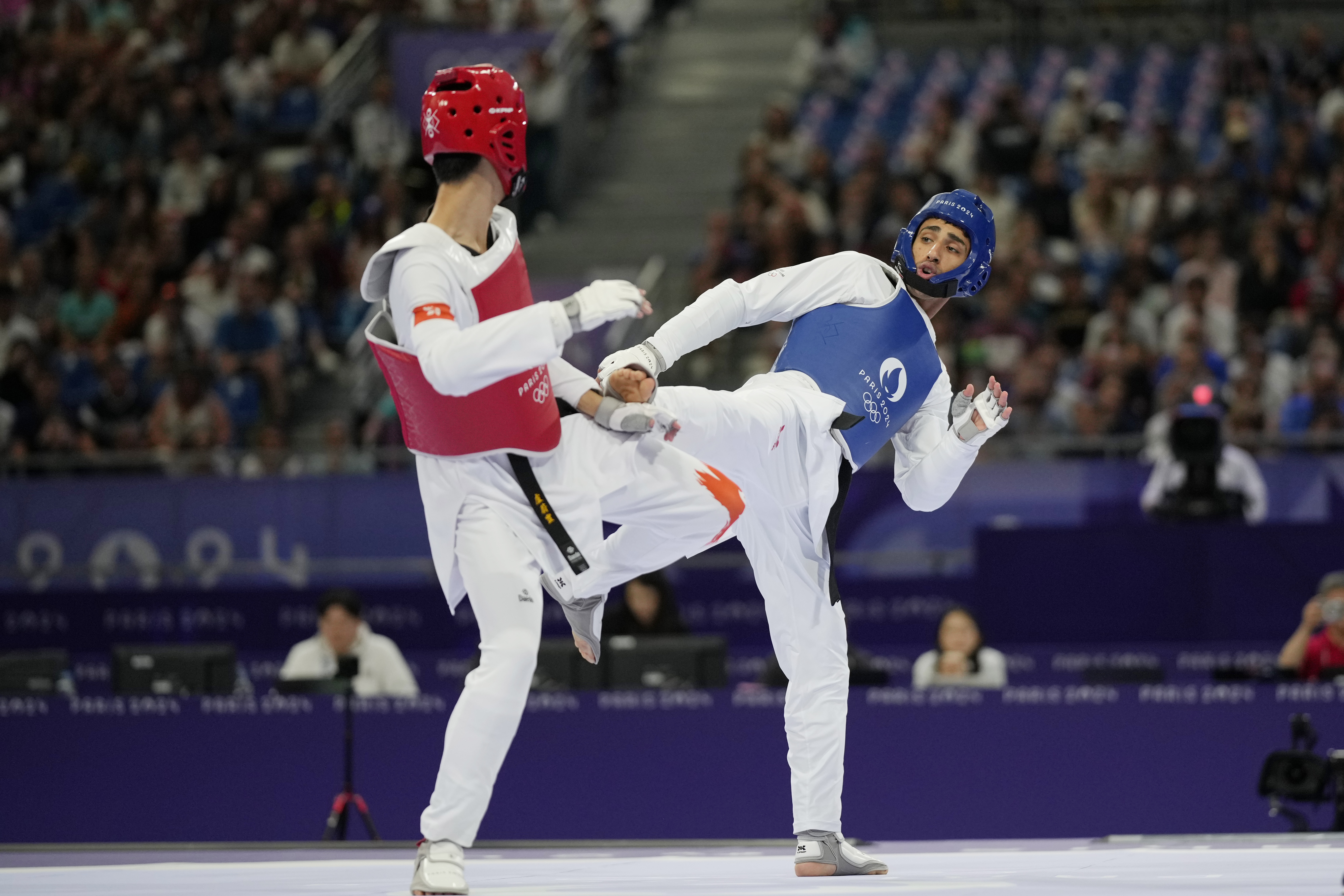 Hong Kong's Lo Wai Fung competes with Refugees Olympic Team's Yahya Al Ghotany in a men's 68kg Taekwondo match during the 2024 Summer Olympics, at the Grand Palais, Thursday, Aug. 8, 2024, in Paris, France. 