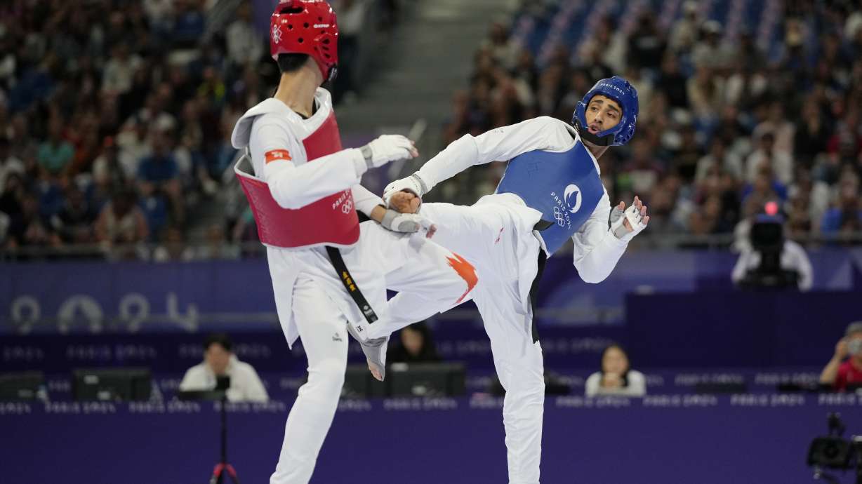 Hong Kong's Lo Wai Fung competes with Refugees Olympic Team's Yahya Al Ghotany in a men's 68kg Taekwondo match during the 2024 Summer Olympics, at the Grand Palais, Thursday, Aug. 8, 2024, in Paris, France.