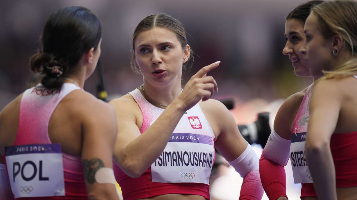 Krystsina Tsimanouskaya, of Poland, gestures as she talks with teammates following their women's 4x100-meter relay heat at the 2024 Summer Olympics, Thursday, Aug. 8, 2024, in Saint-Denis, France.