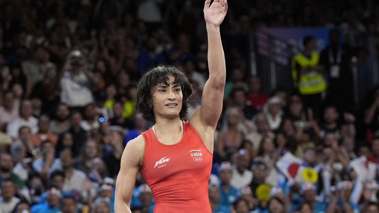 India's Vinesh Vinesh celebrates after defeating Cuba's Yusneylys Guzman during their women's freestyle 50kg wrestling semifinal match, at Champ-de-Mars Arena, during the 2024 Summer Olympics, Tuesday, Aug. 6, 2024, in Paris, France.