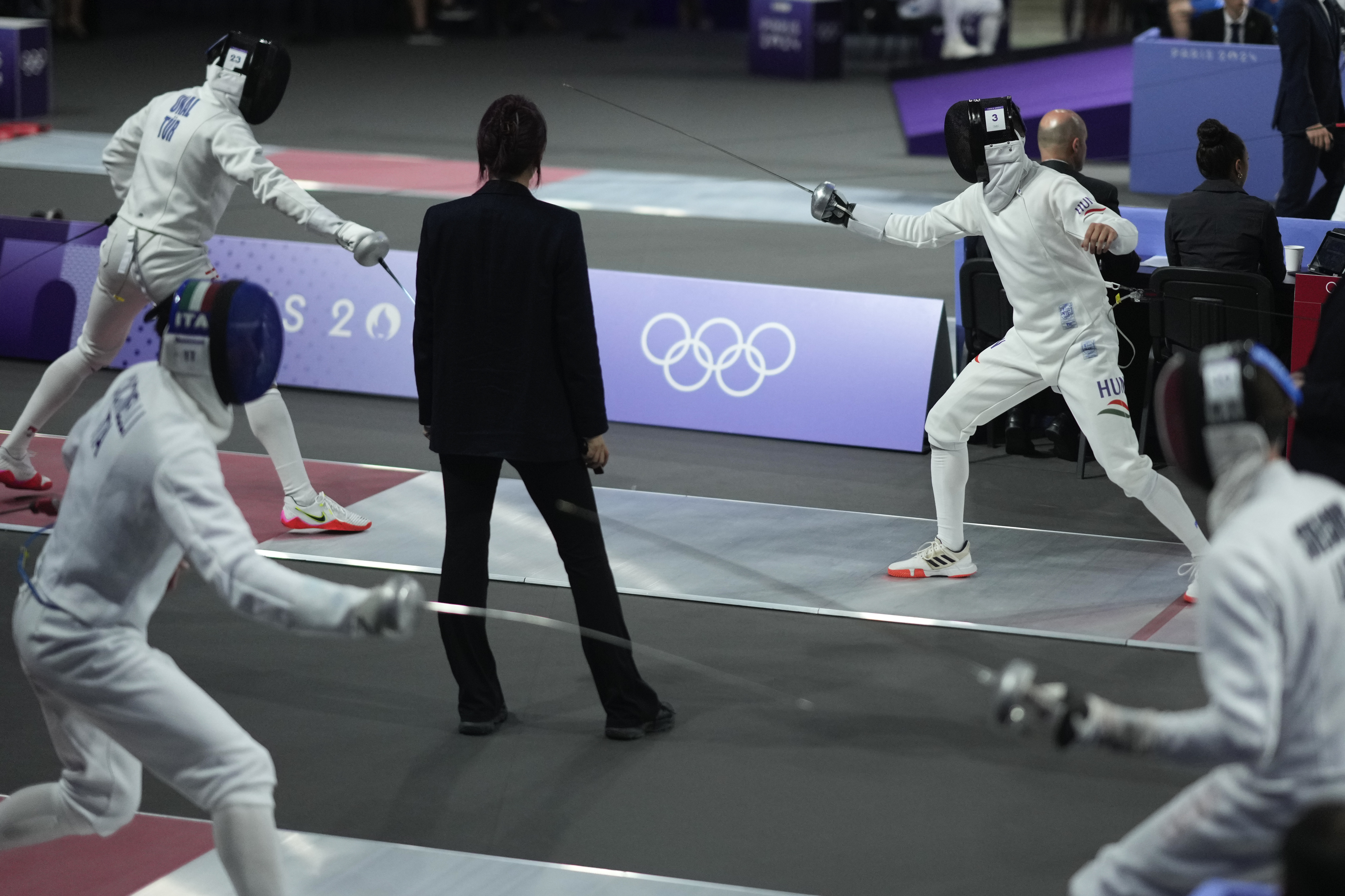 A referee observes as players compete in the men's individual fencing portion of Modern Pentathlon Summer Olympics at the 2024 Summer Olympics, Thursday, Aug. 8, 2024, in Villepinte, France. 
