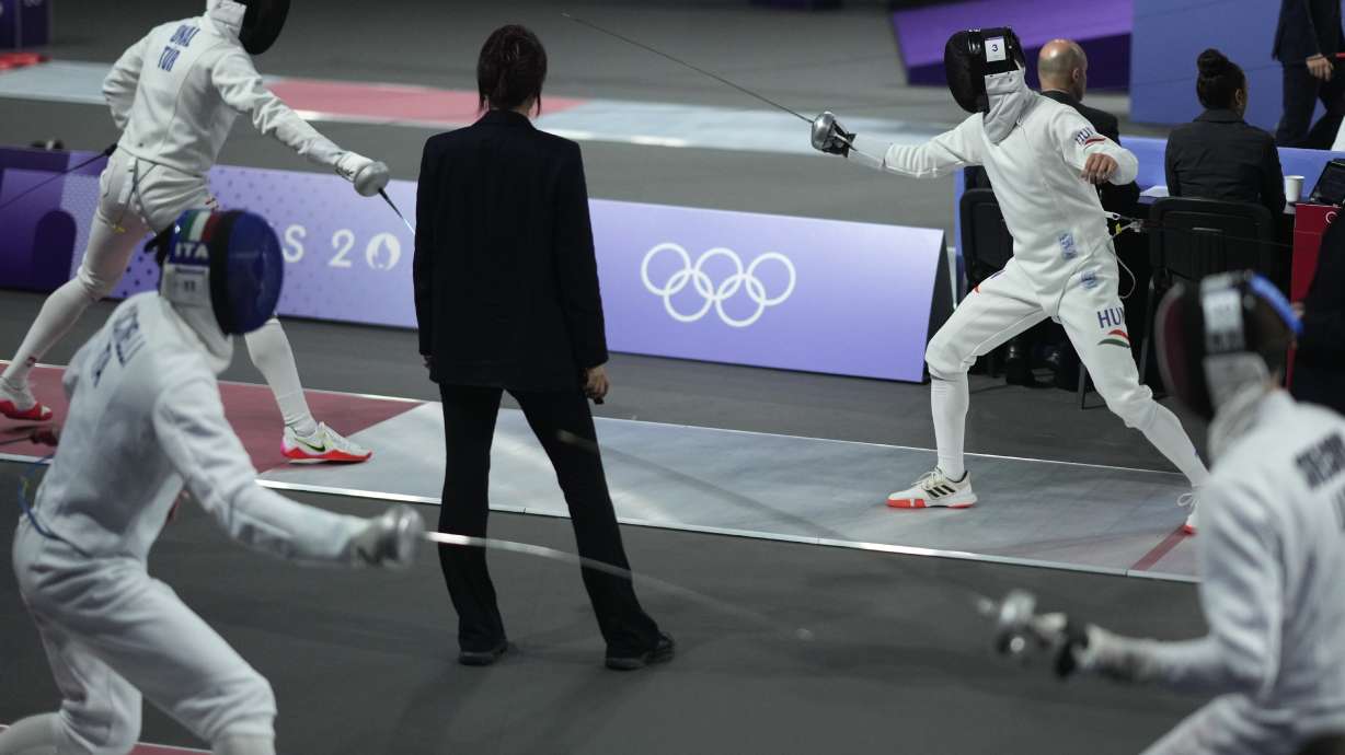 A referee observes as players compete in the men's individual fencing portion of Modern Pentathlon Summer Olympics at the 2024 Summer Olympics, Thursday, Aug. 8, 2024, in Villepinte, France.