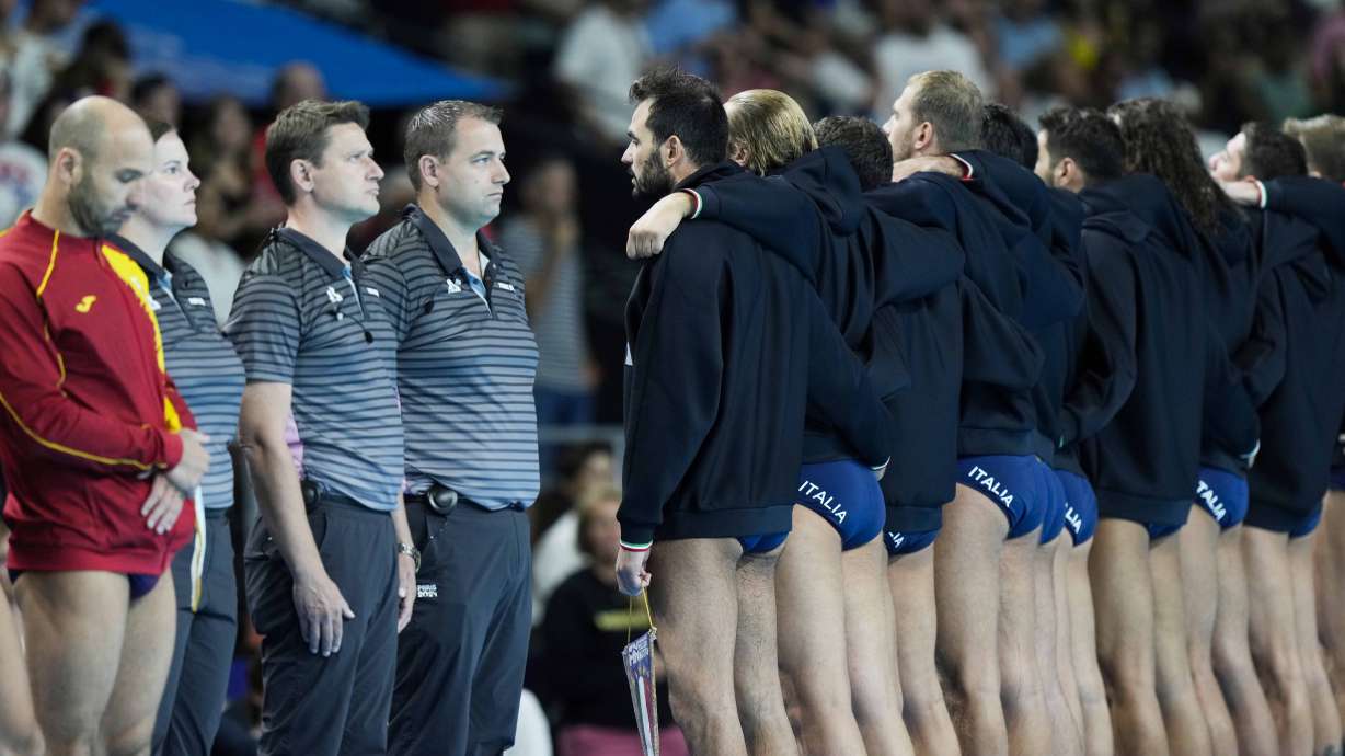 Italian players listen the nation anthems with their backs turned as a protest for the Italy-Hungary refereeing controversy, prior to a men's 5th and 8th place classification match between Italy and Spain, at the 2024 Summer Olympics, Friday, Aug. 9, 2024, in Paris.