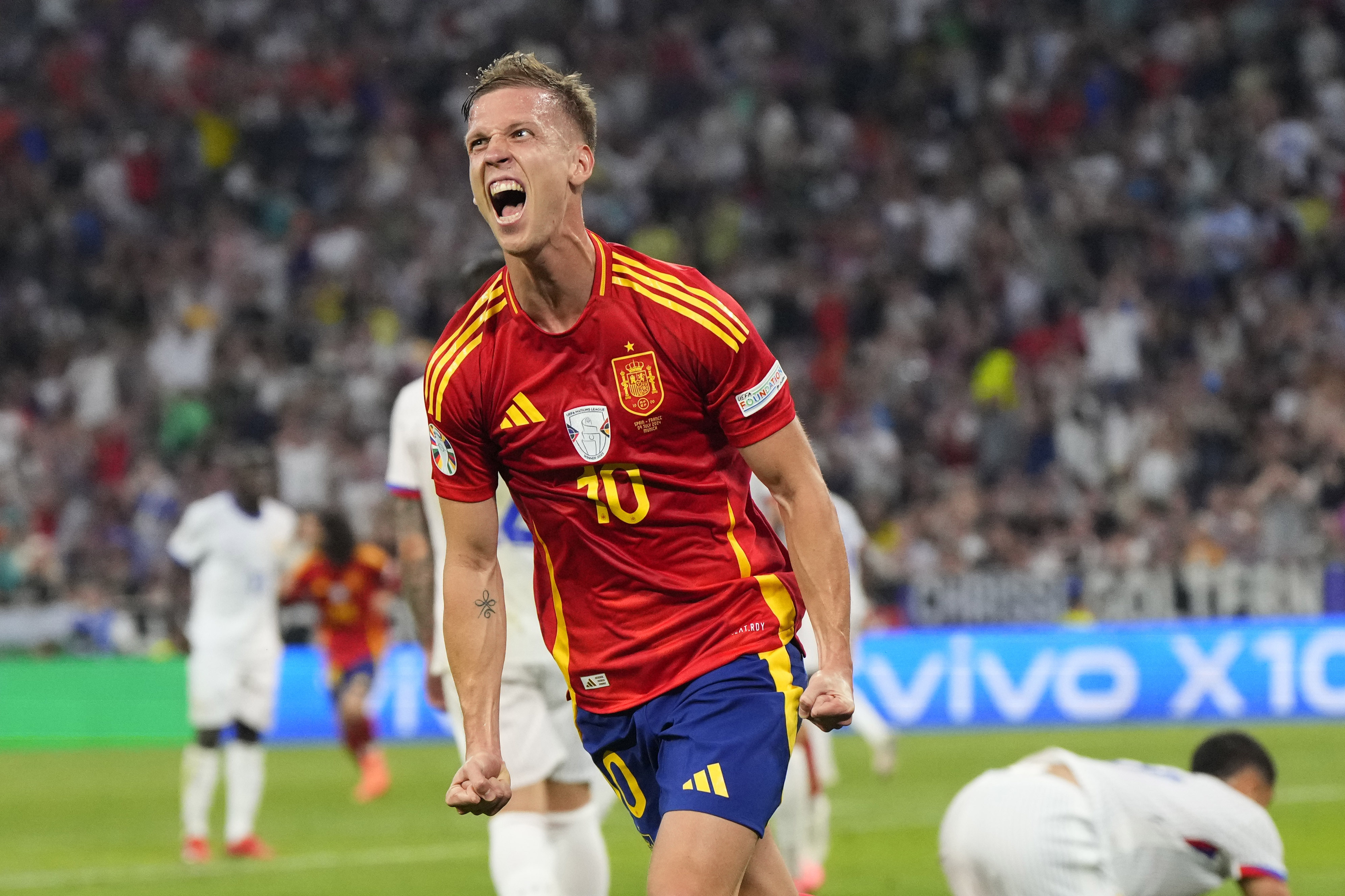 Spain's Dani Olmo celebrates after scoring his side's second goal during a semifinal match between Spain and France at the Euro 2024 soccer tournament in Munich, Germany, Tuesday, July 9, 2024. 