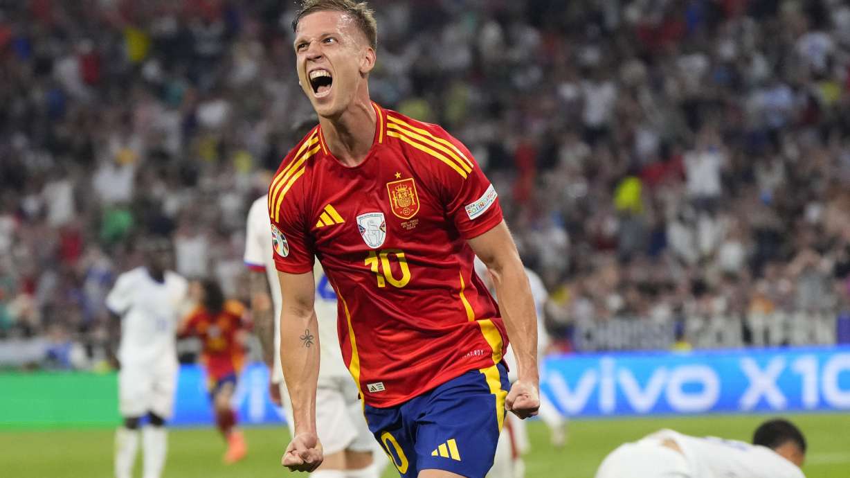 Spain's Dani Olmo celebrates after scoring his side's second goal during a semifinal match between Spain and France at the Euro 2024 soccer tournament in Munich, Germany, Tuesday, July 9, 2024.