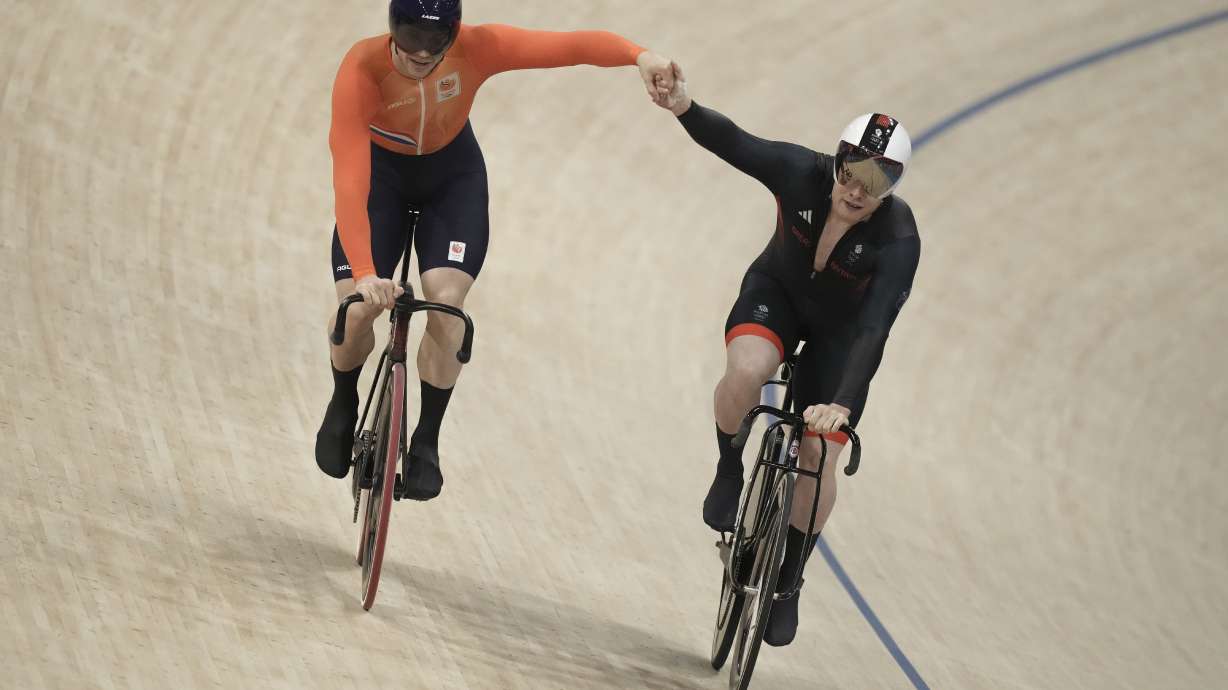 Harrie Lavreysen of Netherlands, left, and Jack Carlin of Britain greet each other as they compete during the men's sprint semifinals, at the Summer Olympics, Friday, Aug. 9, 2024, in Paris, France.