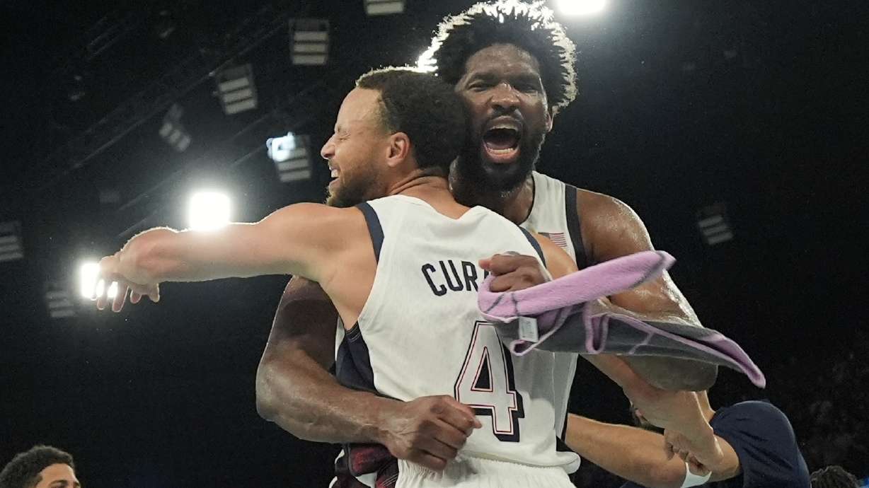 United States' Stephen Curry (4) and United States' Joel Embiid (11) celebrate after a men's semifinals basketball game against Serbia at Bercy Arena at the 2024 Summer Olympics, Thursday, Aug. 8, 2024, in Paris, France.