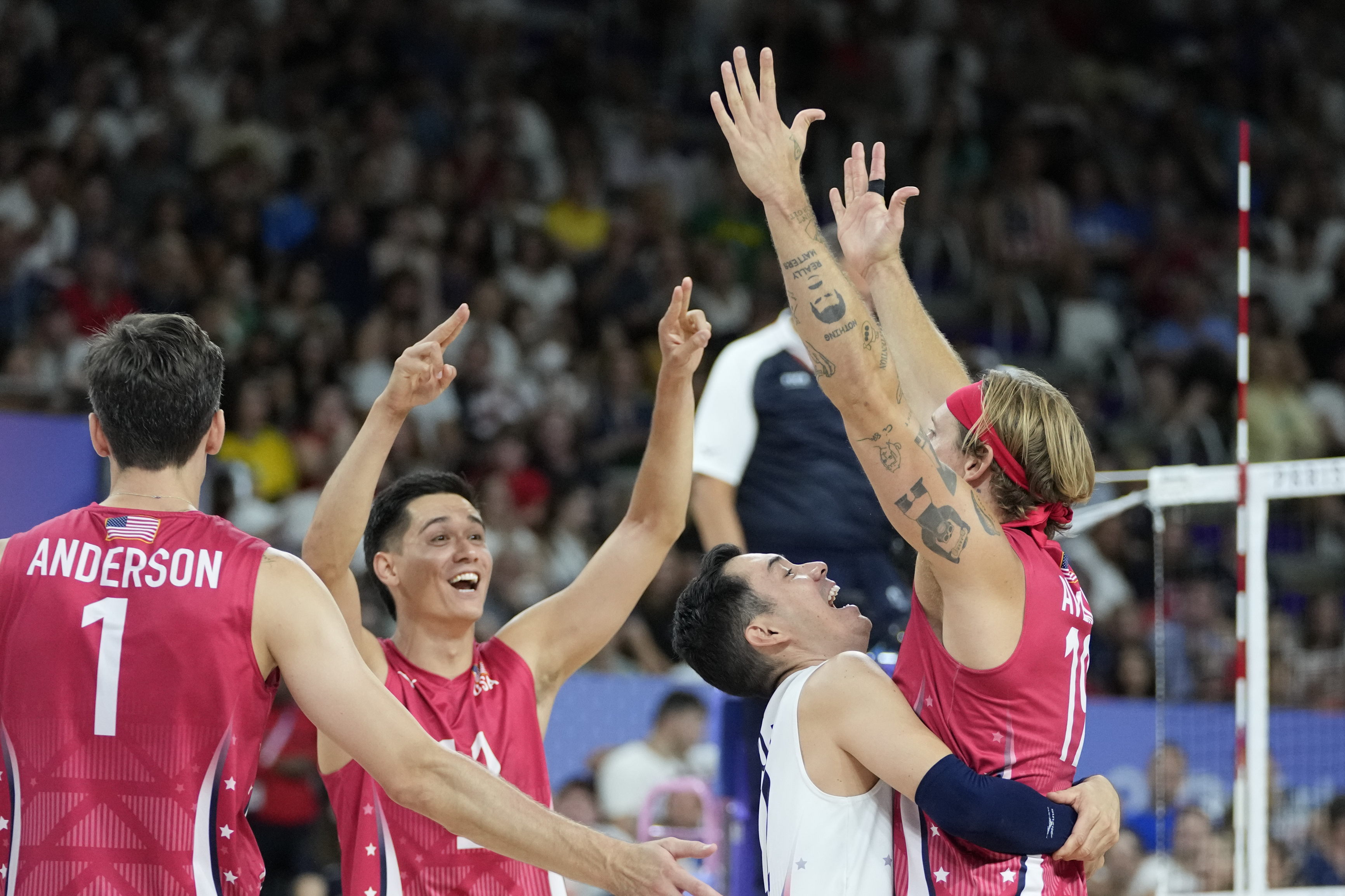 Players of the United States celebrate after scoring a point during the men's bronze medal volleyball match between the United States and Italy at the 2024 Summer Olympics, Friday, Aug. 9, 2024, in Paris, France. 
