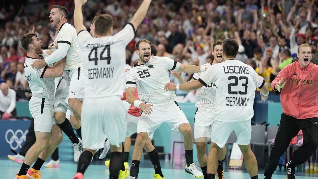 Germany players celebrate their victory after a semifinal handball match between Germany and Spain at the 2024 Summer Olympics, Friday, Aug. 9, 2024, in Villeneuve-d'Ascq, France.