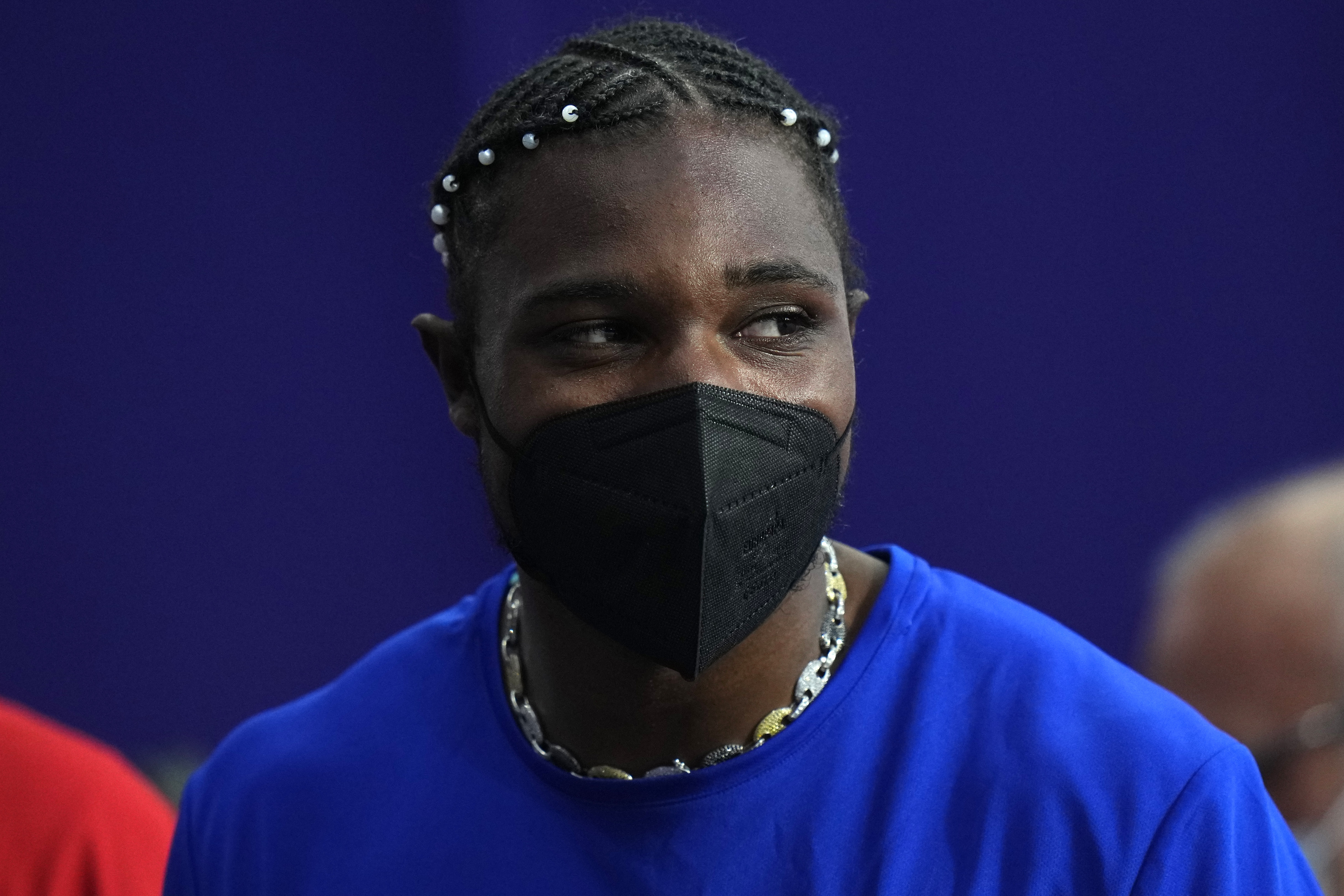 Noah Lyles, of the United States, dons a face mask following his men's 200-meters final at the 2024 Summer Olympics, Thursday, Aug. 8, 2024, in Saint-Denis, France. 