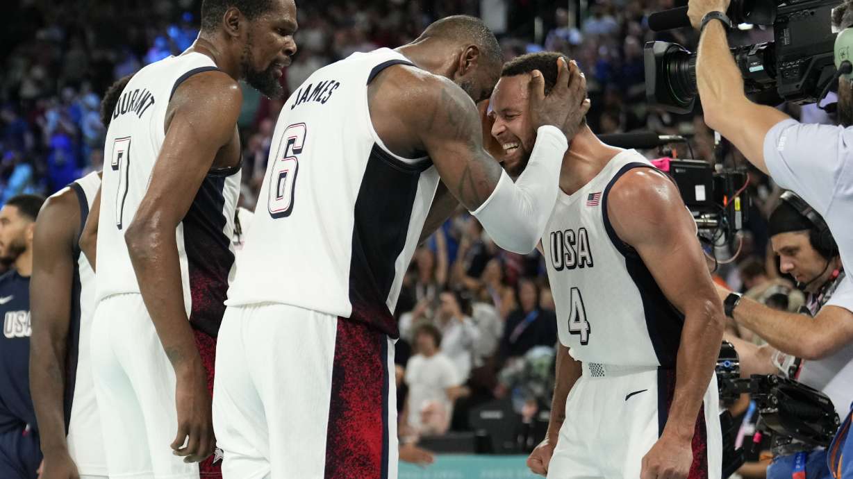United States' Kevin Durant (7), LeBron James (6) and Steph Curry (4) celebrate after beating Serbia during a men's semifinals basketball game at Bercy Arena at the 2024 Summer Olympics, Thursday, Aug. 8, 2024, in Paris, France.