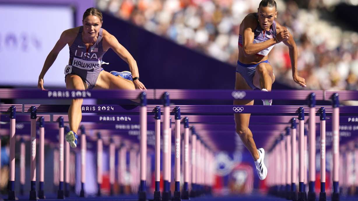 Anna Hall, right, of the United States, and Chari Hawkins on the United States, compete in the women's heptathlon 100-meter hurdles at the 2024 Summer Olympics, Thursday, Aug. 8, 2024, in Saint-Denis, France.