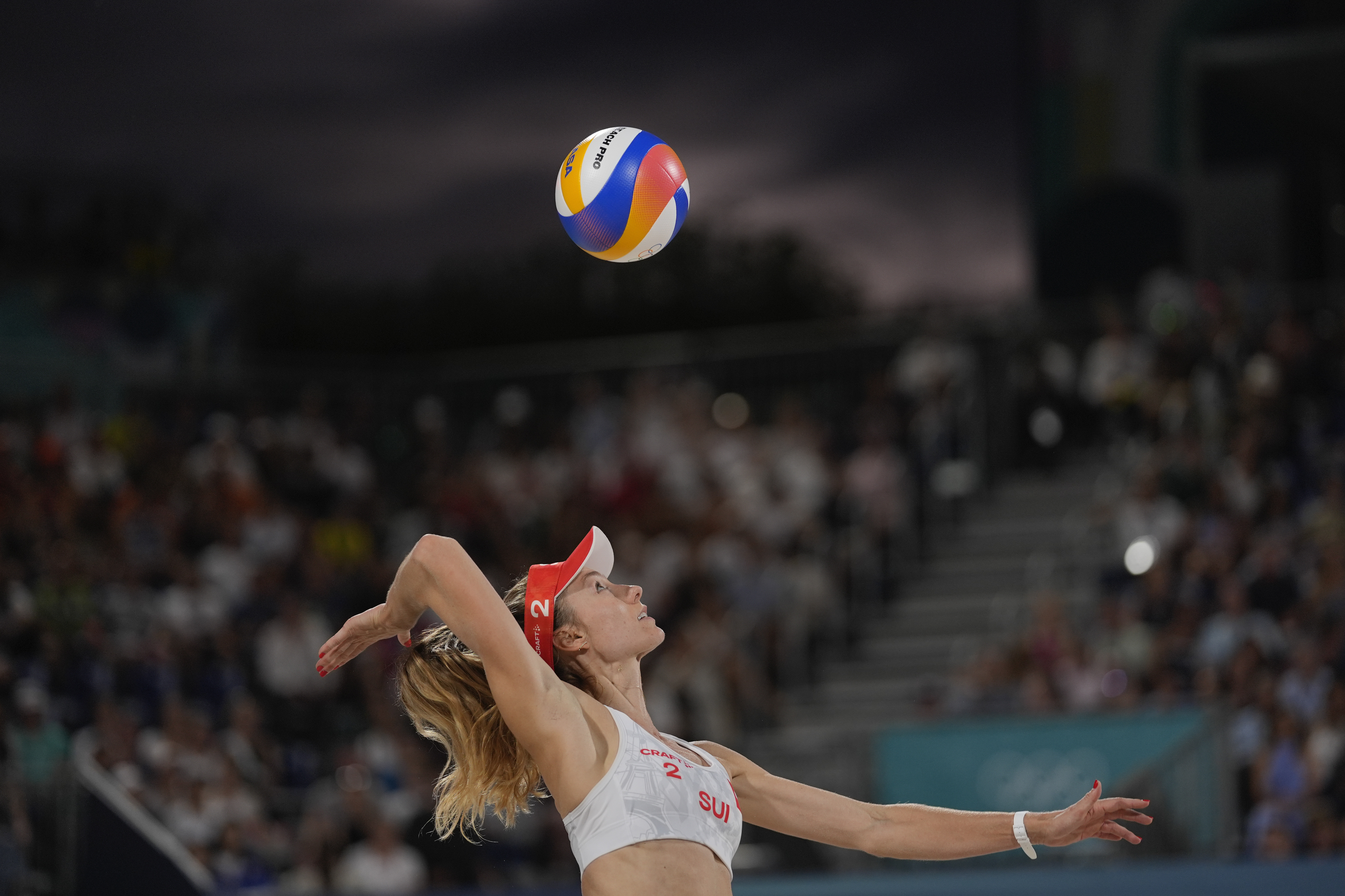 Switzerland's Nina Brunner serves in the women's beach volleyball bronze medal match between Australia and Switzerland, at the 2024 Summer Olympics, Friday, Aug. 9, 2024, in Paris, France. 