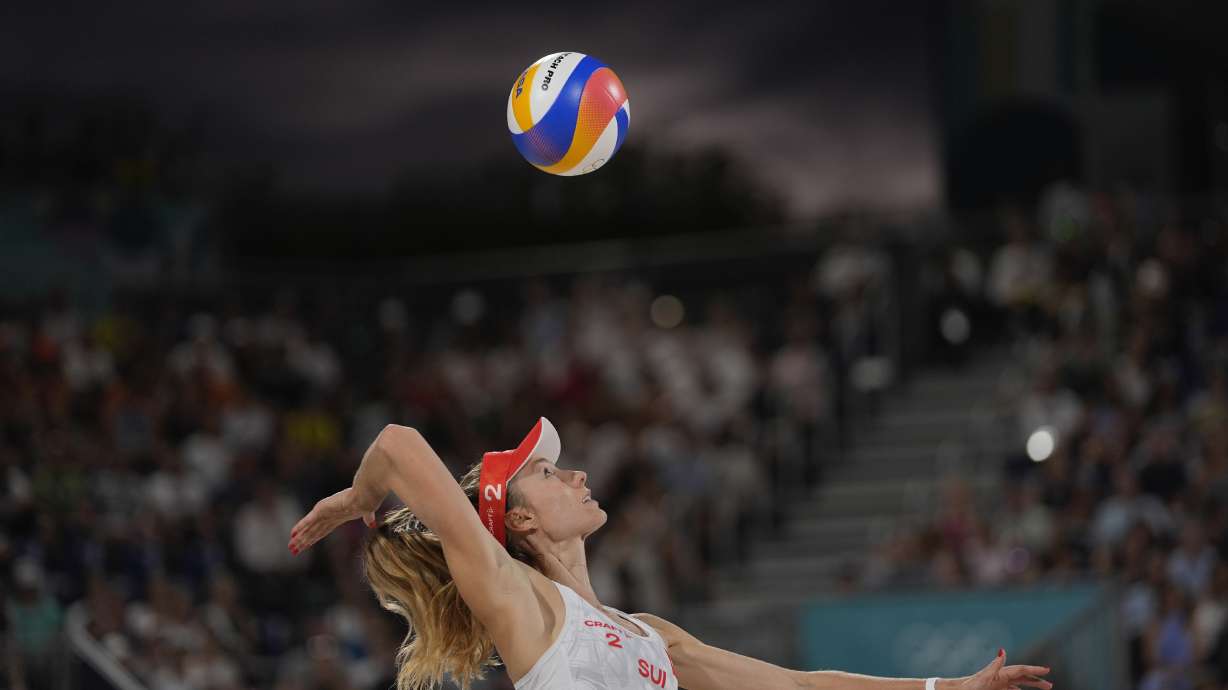 Switzerland's Nina Brunner serves in the women's beach volleyball bronze medal match between Australia and Switzerland, at the 2024 Summer Olympics, Friday, Aug. 9, 2024, in Paris, France.