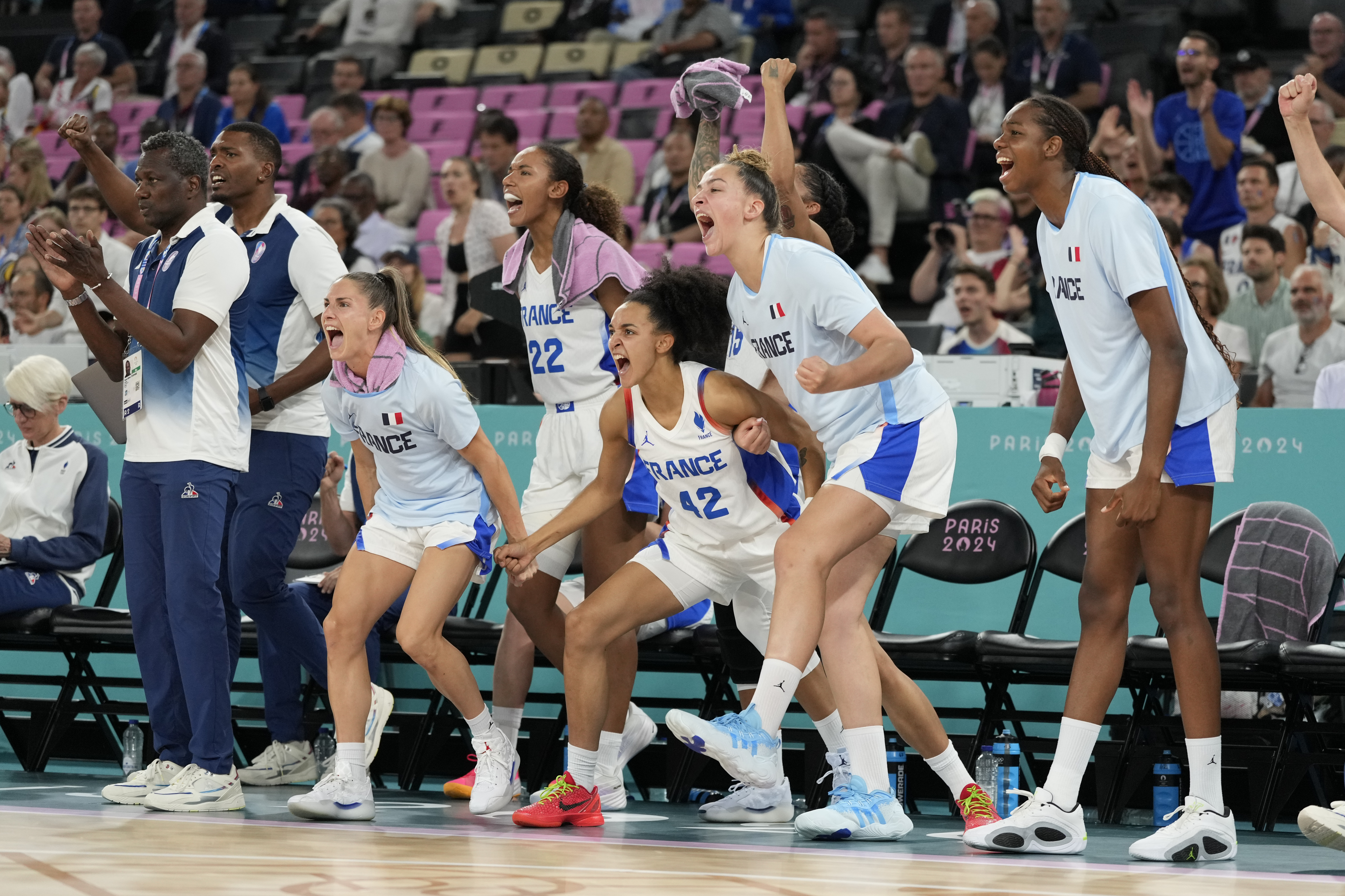 Team France bench celebrate a basket against Belgium during a women's semifinal basketball game at Bercy Arena at the 2024 Summer Olympics, Friday, Aug. 9, 2024, in Paris, France.