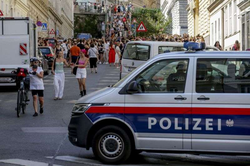 A police car stands near gathering "Swifties" in Vienna on Friday. Organizers of three Taylor Swift concerts in the stadium in Vienna this week called them off on Wednesday after officials announced arrests over an apparent plot to launch an attack on an event in the Vienna area such as the concerts.