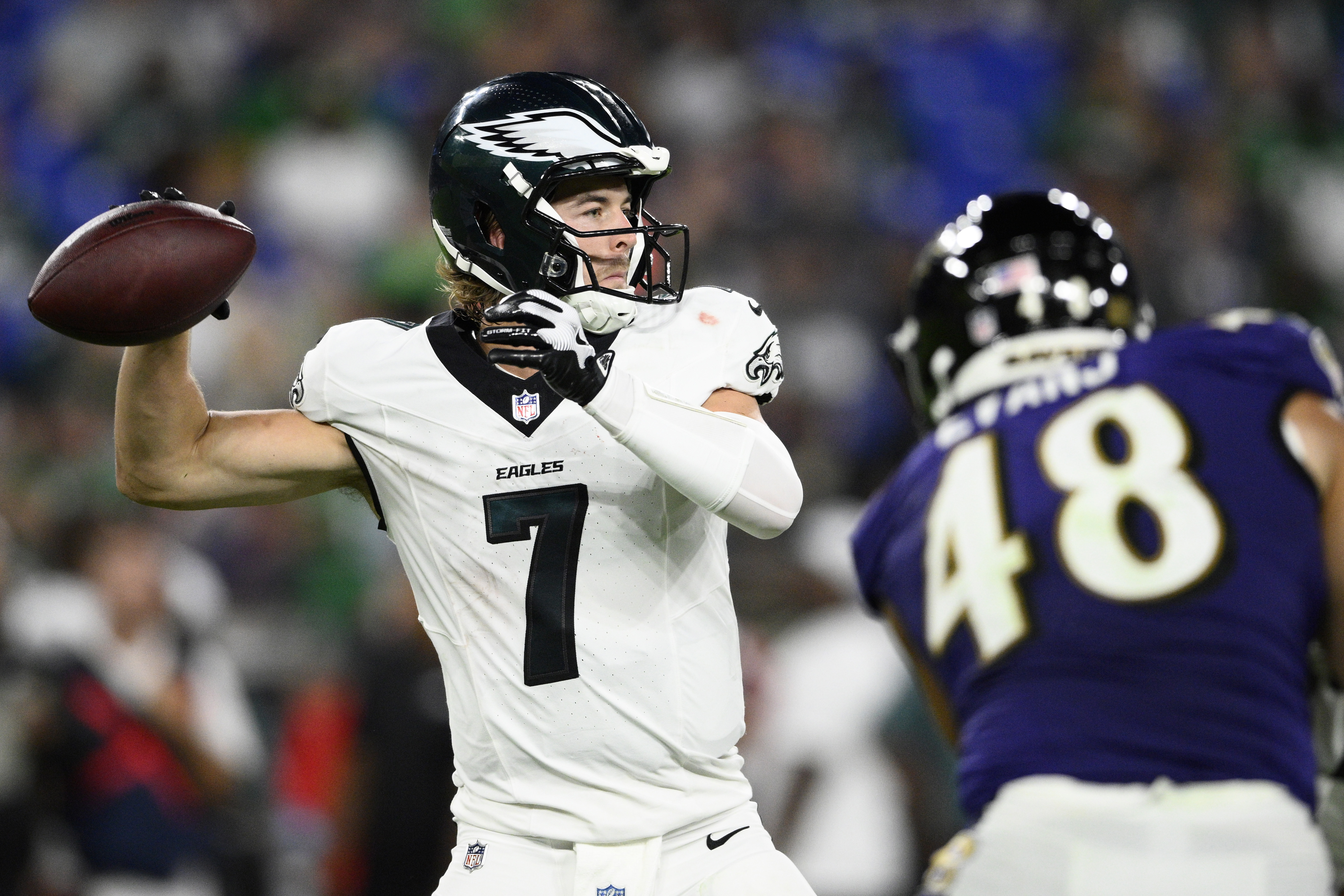 Philadelphia Eagles' Kenny Pickett, left, passes under pressure from Baltimore Ravens' Joe Evans during the first half of a preseason NFL football game, Friday, Aug. 9, 2024, in Baltimore.