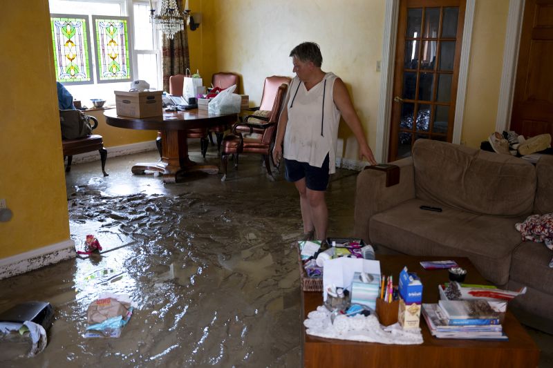 Ann Farkas walks in her flood-damaged home in Canisteo, N.Y., Friday after remnants of Tropical Storm Debby swept tough the area, creating flash flood conditions in some areas.