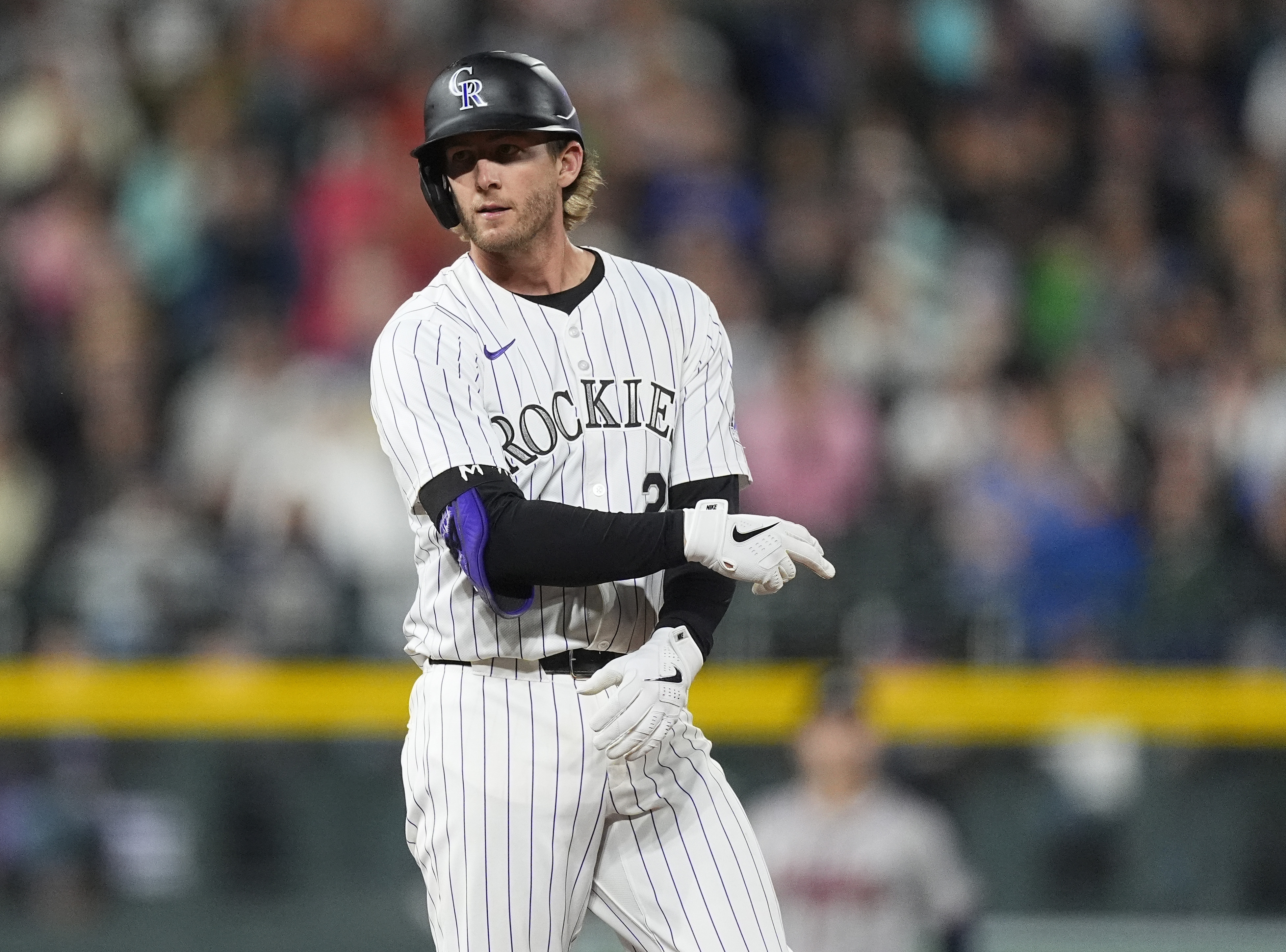 Colorado Rockies' Ryan McMahon gestures to the dugout after hitting an RBI double off Atlanta Braves relief pitcher A.J. Minter in the seventh inning of a baseball game Friday, Aug. 9, 2024, in Denver. 