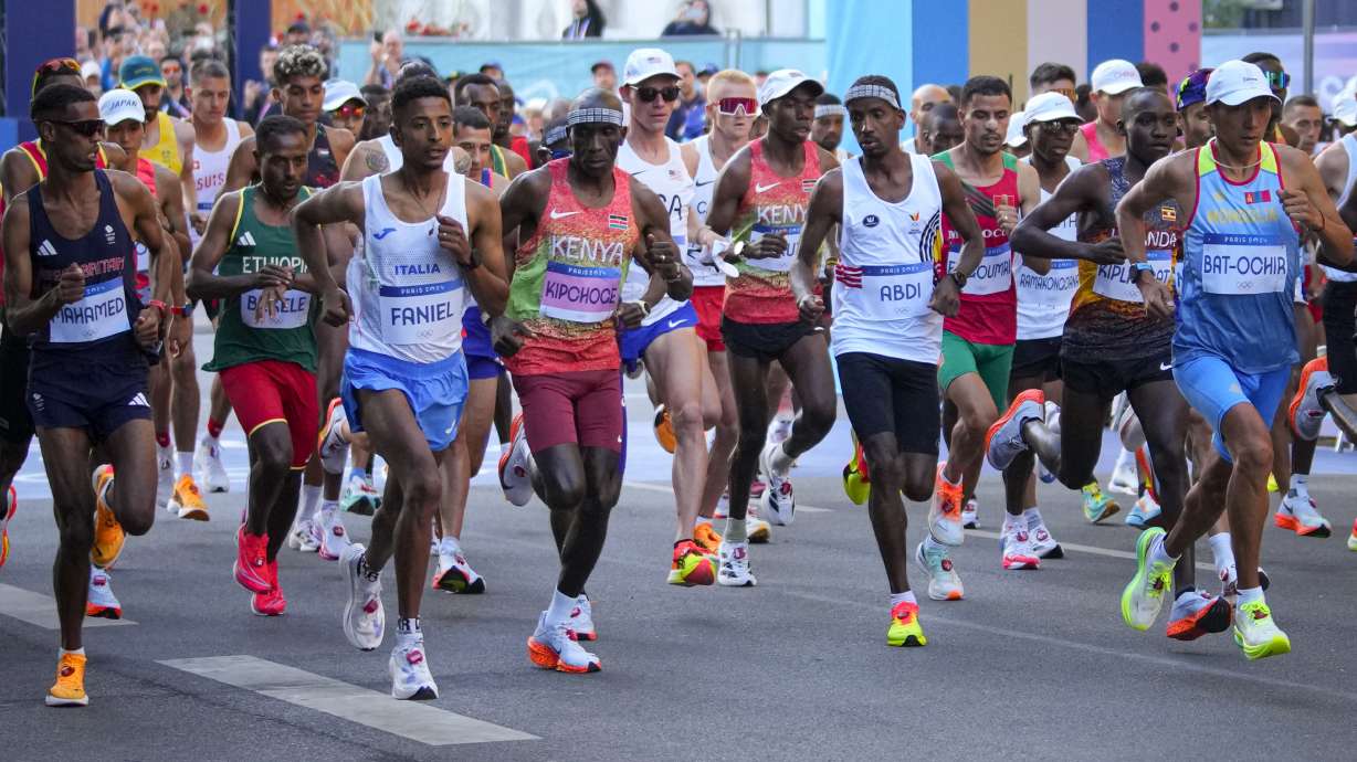 Kenya's Elius Kipchoge (C) competes at the start of the men's marathon competition with former BYU and American Fork High athlete Clayton Young (middle) at the 2024 Summer Olympics, Saturday, Aug. 10, 2024, in Paris, France.