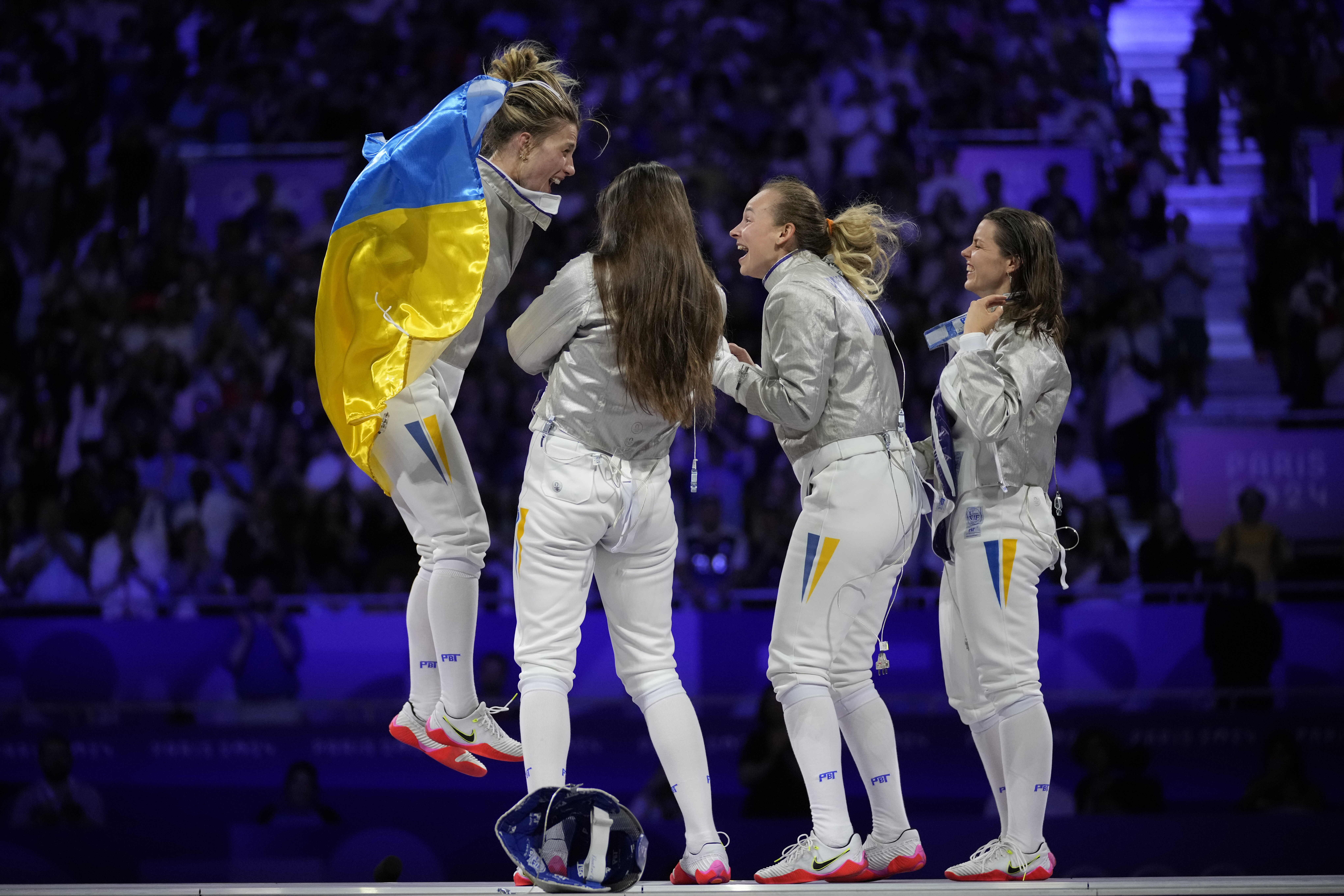 Ukraine's Olga Kharlan, left, celebrates with her teammates after winning the women's team sabre final match against South Korea during the 2024 Summer Olympics at the Grand Palais, Saturday, Aug. 3, 2024, in Paris, France.