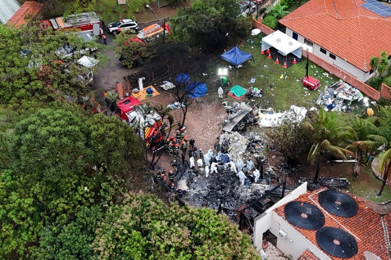 A drone view shows people working at the site of a plane crash in Vinhedo, Sao Paulo, Brazil, Saturday.