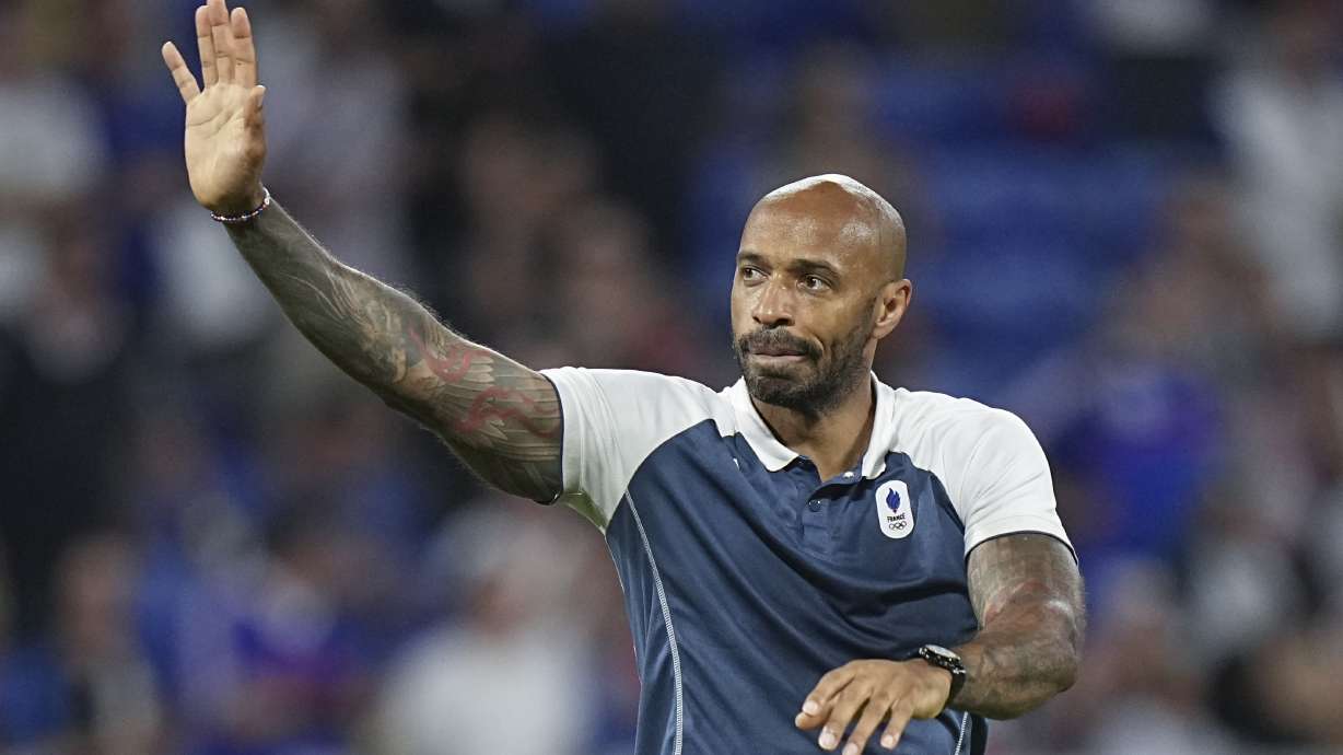 France's head coach Thierry Henry waves to fans as he celebrates his team's victory over Egypt at the end of the men's semifinal soccer match at Lyon Stadium, during the 2024 Summer Olympics, Monday, Aug. 5, 2024, in Decines, France.