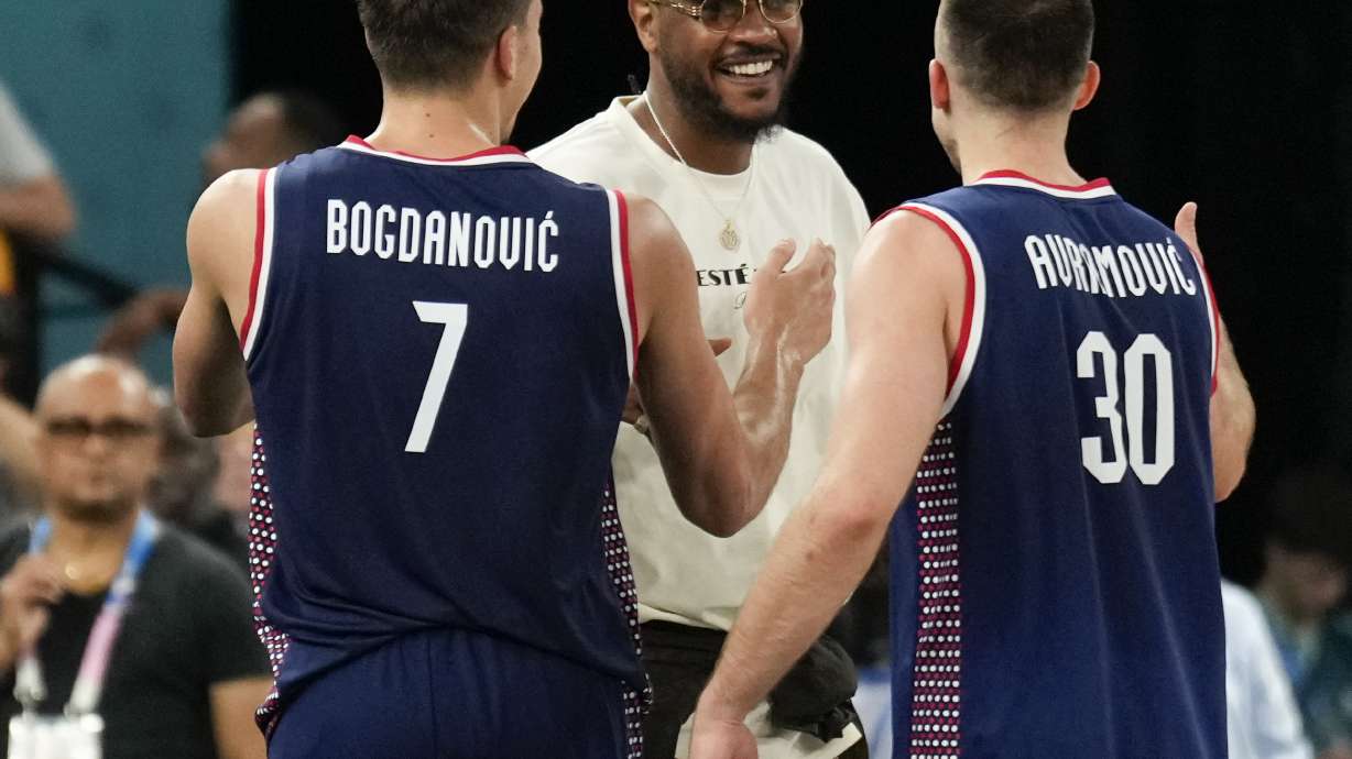 Bogdan Bogdanovic (7), of Serbia and Aleksa Avramovic (30), of Serbia greet Carmelo Anthony after Serbia beat Germany during a men's bronze medal basketball game at Bercy Arena at the 2024 Summer Olympics, Saturday, Aug. 10, 2024, in Paris, France.
