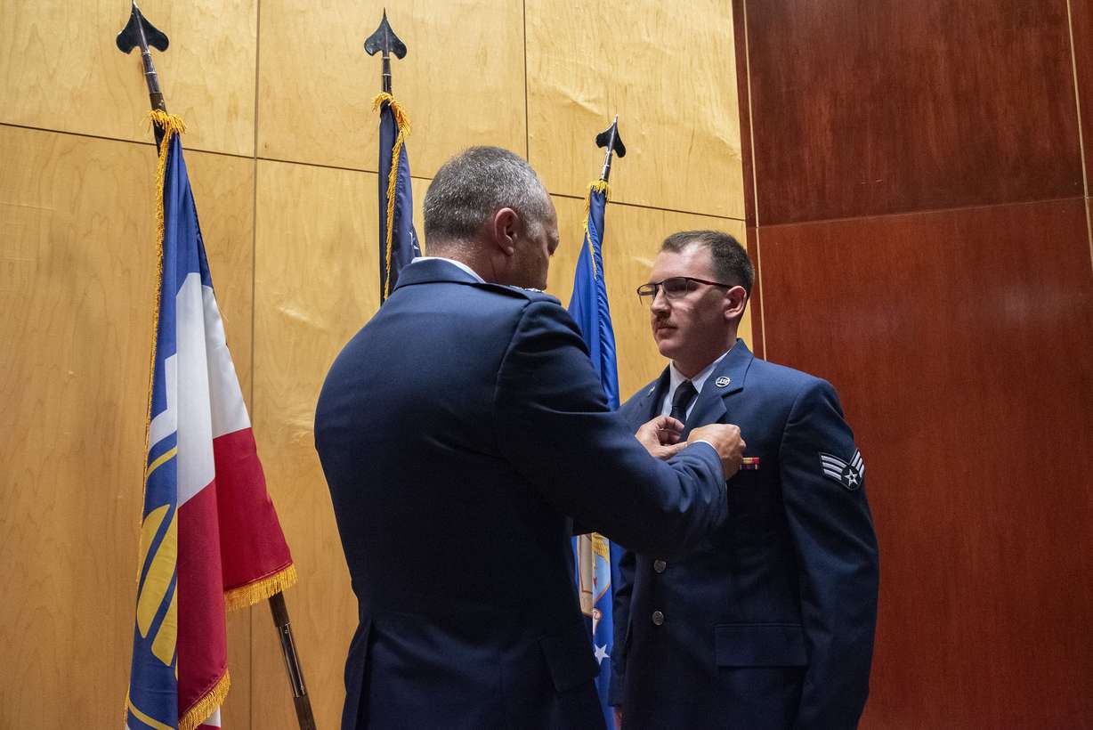 Maj. Gen. Daniel Boyack pins the Airman's Medal on Airman 1st Class Jacob Teel at a ceremony Aug. 4.