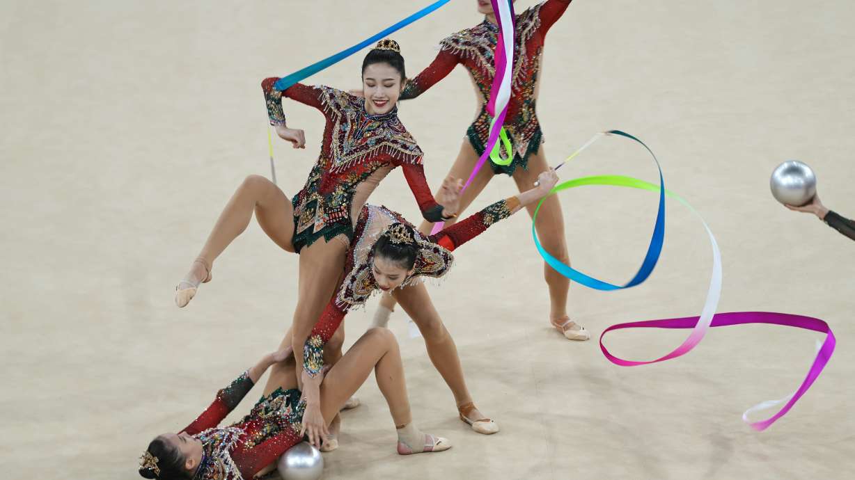 Team China performs with ribbons and balls in the group all-around rhythmic gymnastics final at La Chapelle Arena during the 2024 Summer Olympics, Saturday, Aug. 10, 2024, in Paris, France.