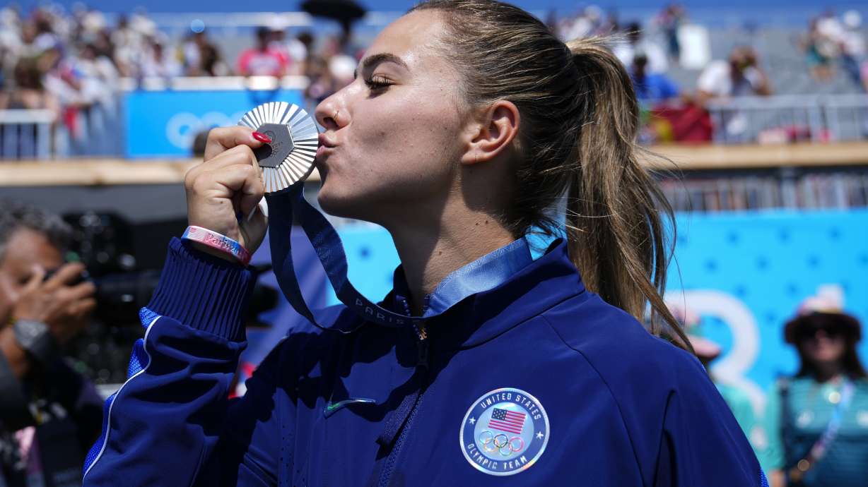Nevin Harrison, of the United States, celebrates with the silver medal for the women's canoe single 200-meter finals at the 2024 Summer Olympics, Saturday, Aug. 10, 2024, in Vaires-sur-Marne, France.