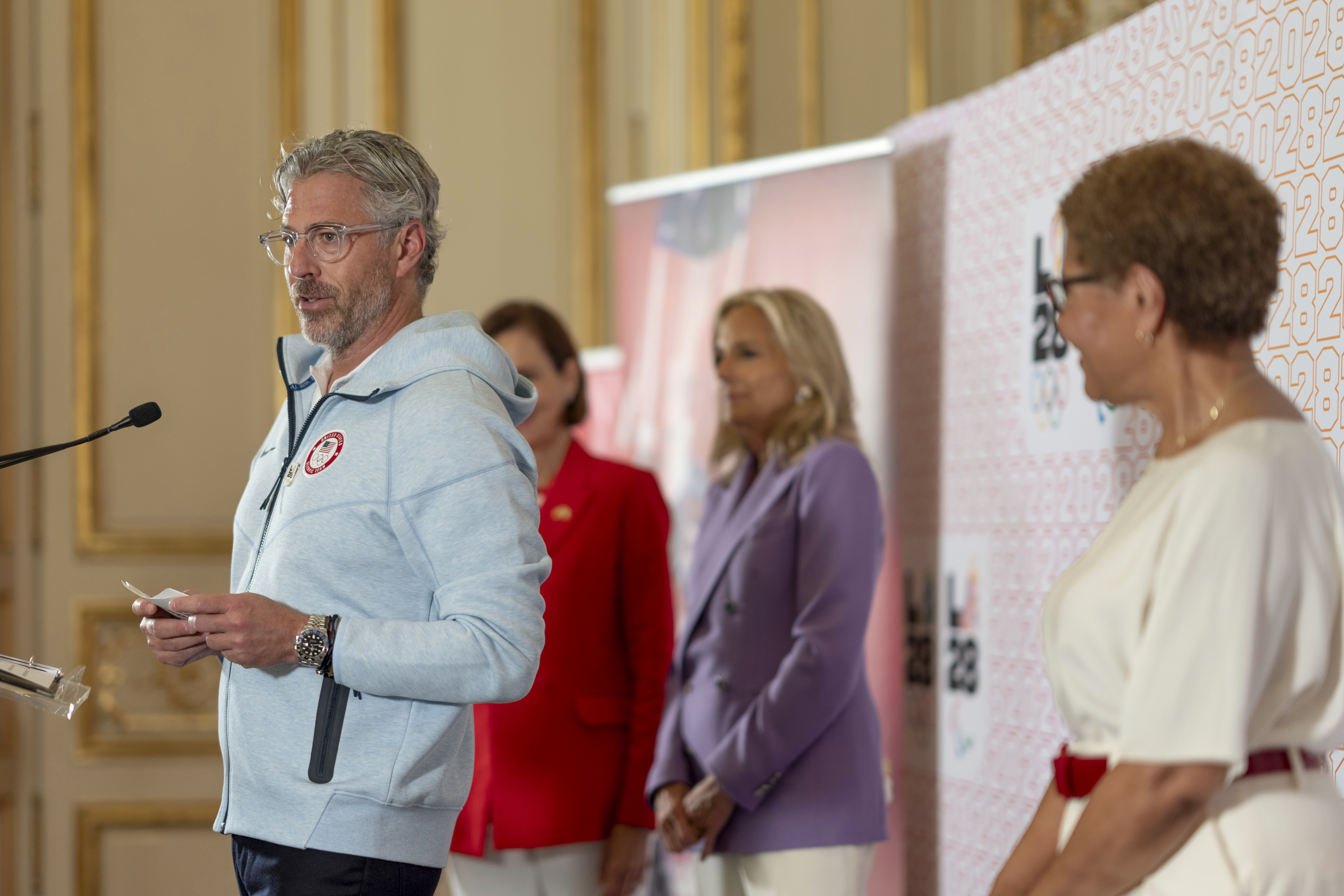 LA28 Chairperson Casey Wasserman, from left, is joined by U.S ambassador to France Denise Campbell Bauer, First lady Jill Biden and Los Angeles Mayor Karen Bass at the Chief of Mission Residence to commemorate the opening of the 2024 Summer Olympics and celebrate the upcoming 2028 Olympic Games, to be held in Los Angeles, Saturday, July 27, 2024, in Paris. 