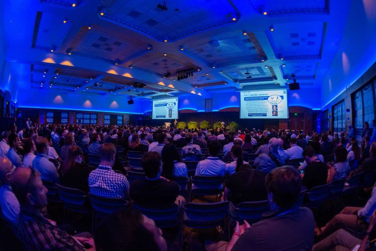 Conference participant listen to a presentation during the 2022 SmallSat conference in Logan, Utah.