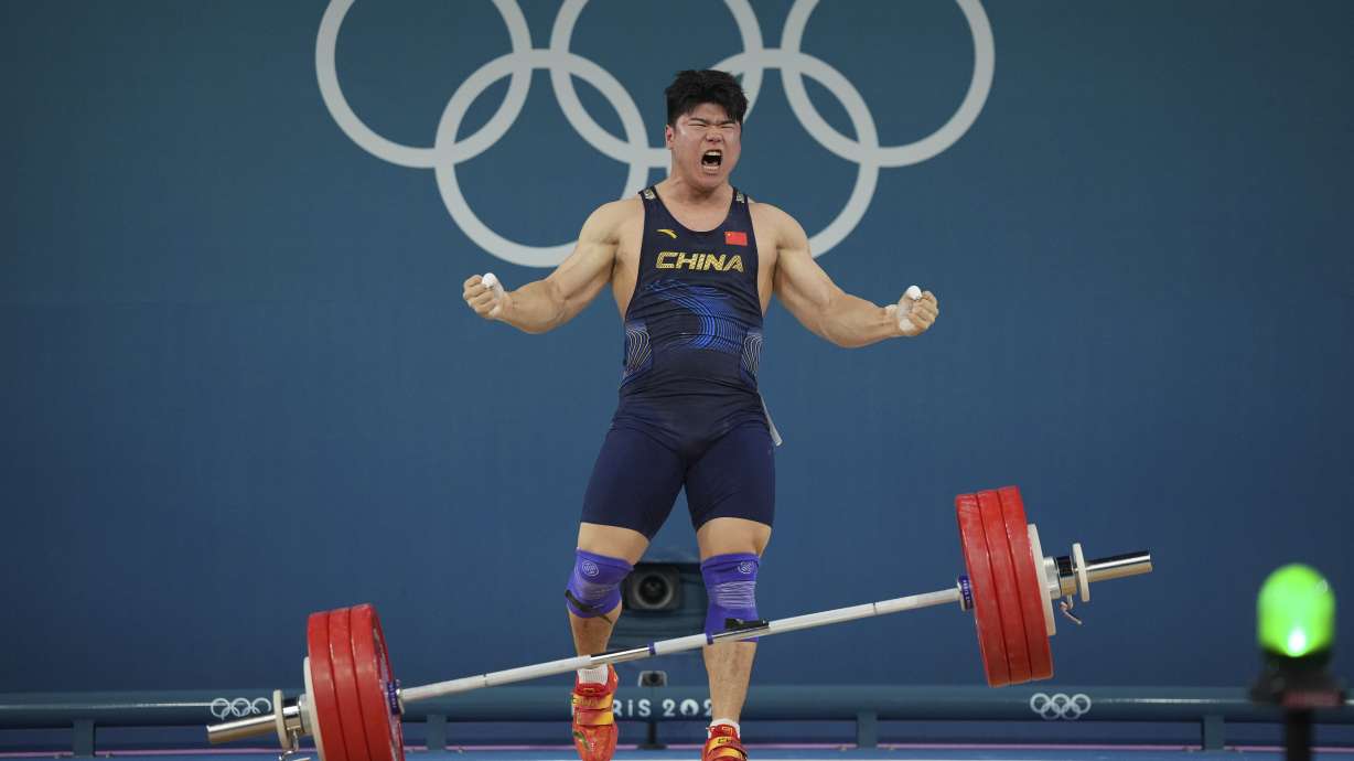 Liu Huanhua of China reacts after a good lift during the men's 102kg weightlifting event, at the 2024 Summer Olympics, Saturday, Aug. 10, 2024, in Paris, France.