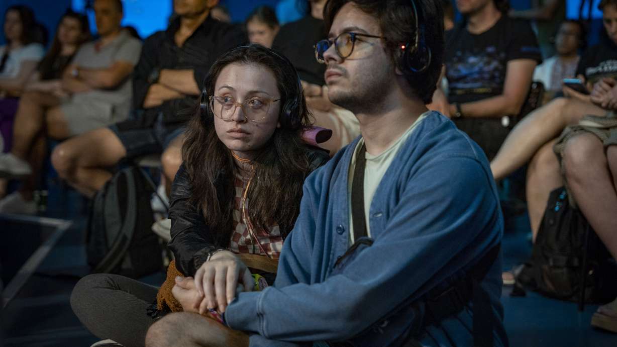 People listen to a public talk at the Ukrainian House in Paris, France, Sunday, Aug. 4, 2024.