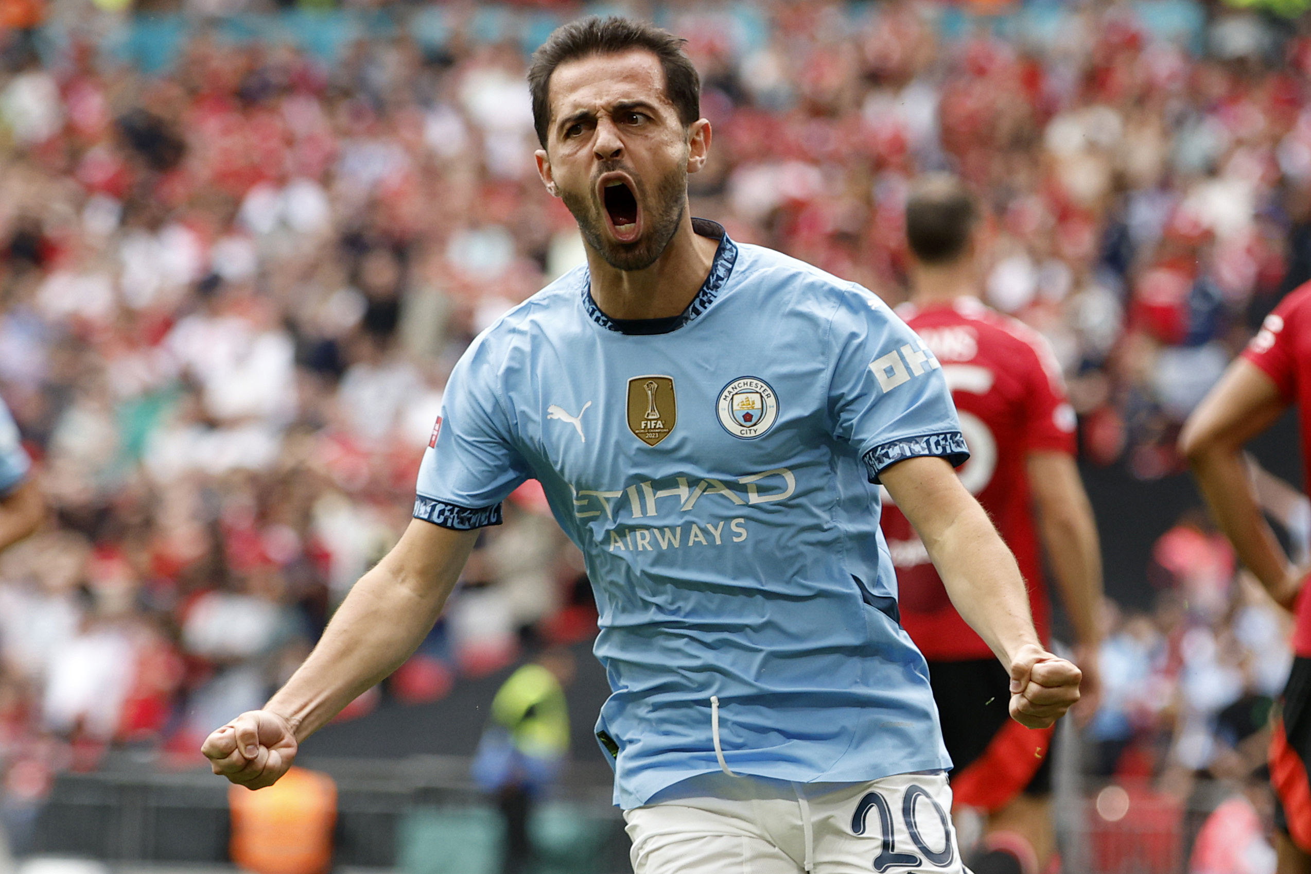 Manchester City midfielder Bernardo Silva celebrates scoring his side's first goal during the FA Community Shield soccer match between Manchester City and Manchester United at Wembley Stadium in London, Saturday, Aug. 10, 2024. 