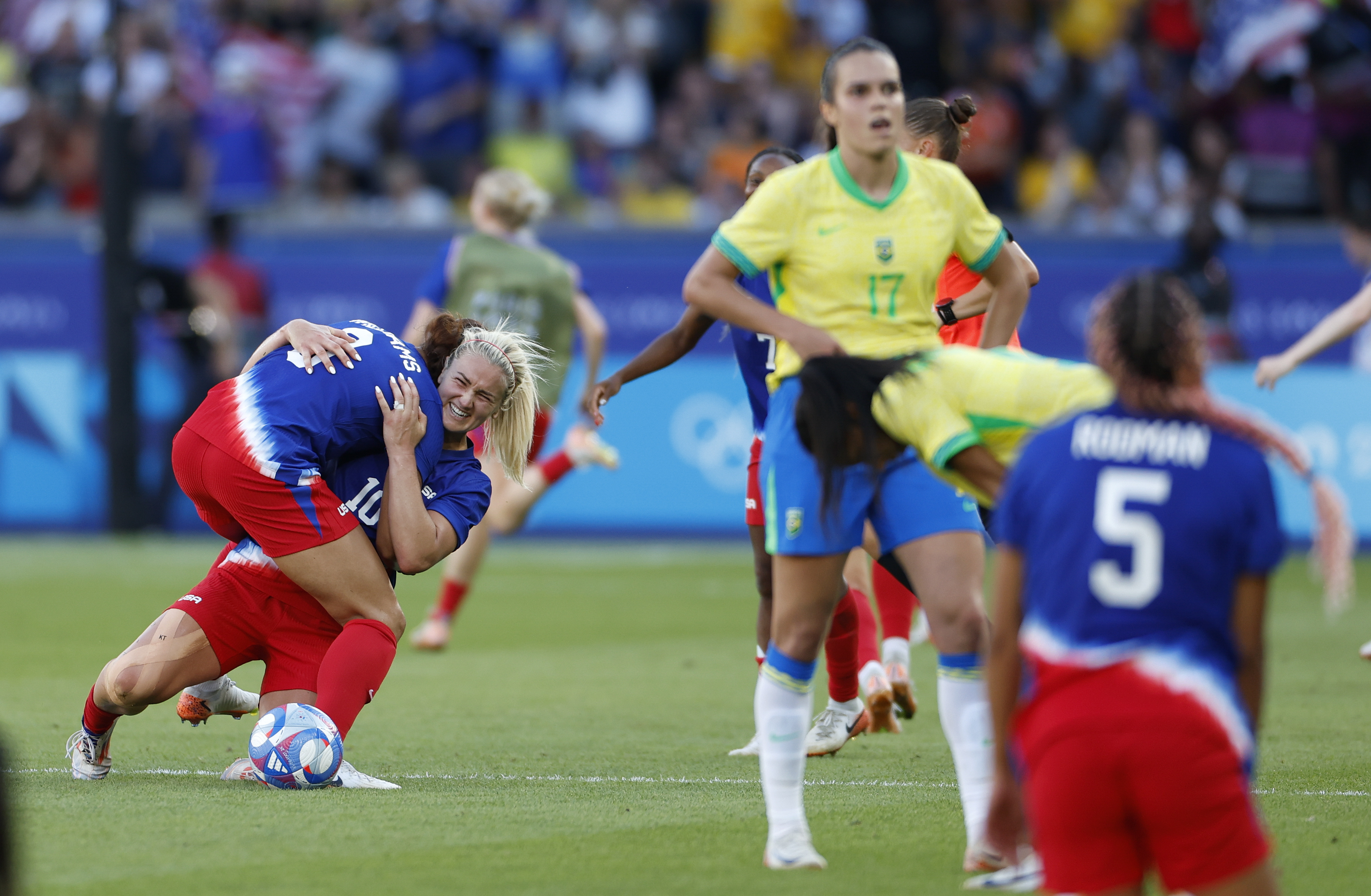 Lindsey Horan of the United States, center, celebrates with her teammates after winning the women's soccer gold medal match between Brazil and the United States at the Parc des Princes during the 2024 Summer Olympics, Saturday, Aug. 10, 2024, in Paris, France.