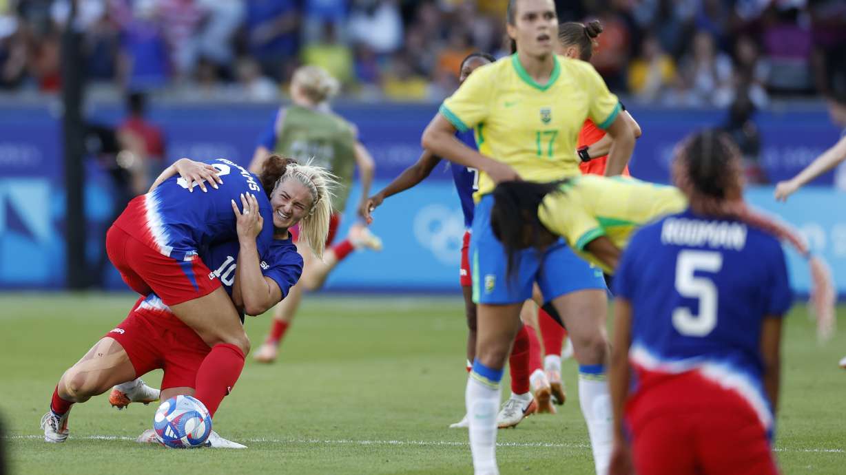 Lindsey Horan of the United States, center, celebrates with her teammates after winning the women's soccer gold medal match between Brazil and the United States at the Parc des Princes during the 2024 Summer Olympics, Saturday, Aug. 10, 2024, in Paris, France.