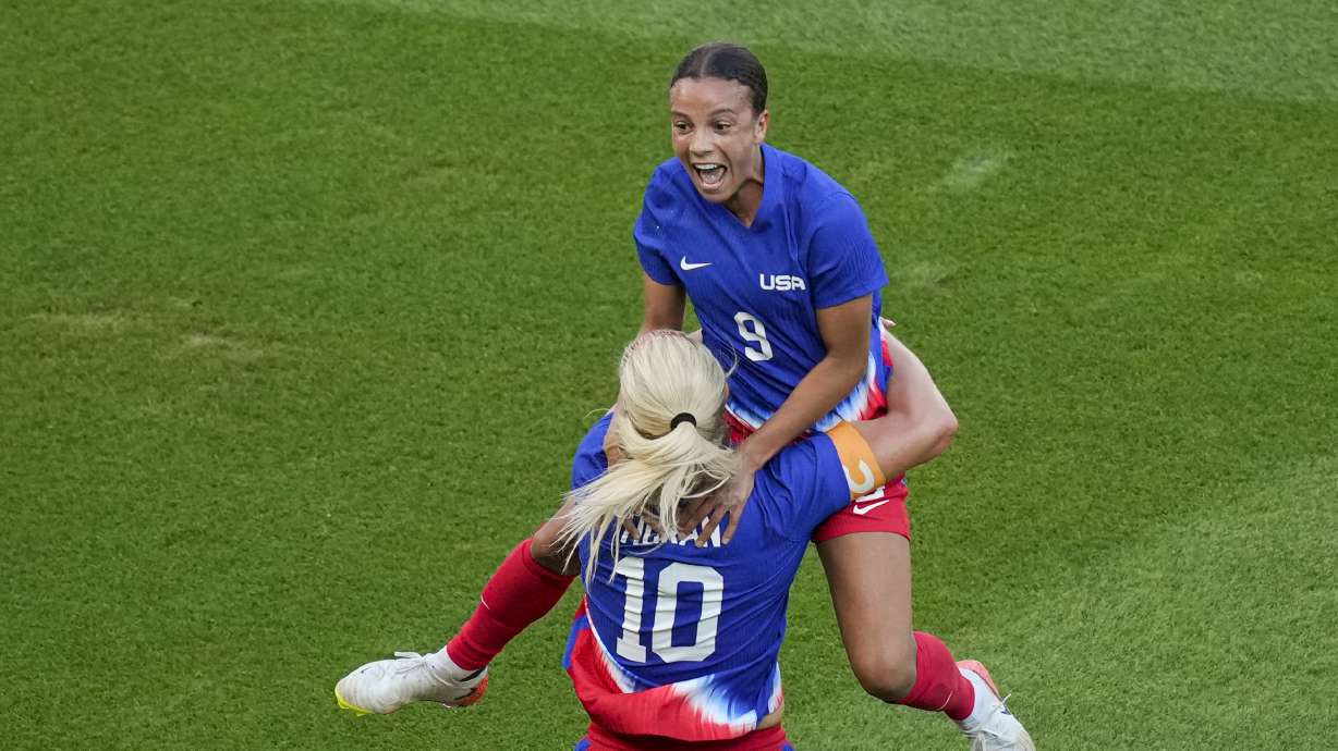 Mallory Swanson, of the United States, up, celebrates with Lindsey Horan, of the United States, after scoring her side's first goal during the women's soccer gold medal match between Brazil and the United States at the Parc des Princes during the 2024 Summer Olympics, Saturday, Aug. 10, 2024, in Paris, France.