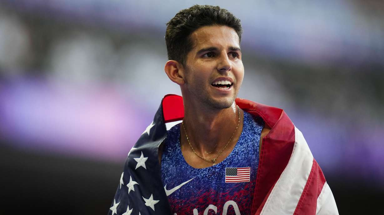 Grant Fisher, of the United States, celebrates after winning a bronze medal in the men's 5000-meter final at the 2024 Summer Olympics, Saturday, Aug. 10, 2024, in Saint-Denis, France.