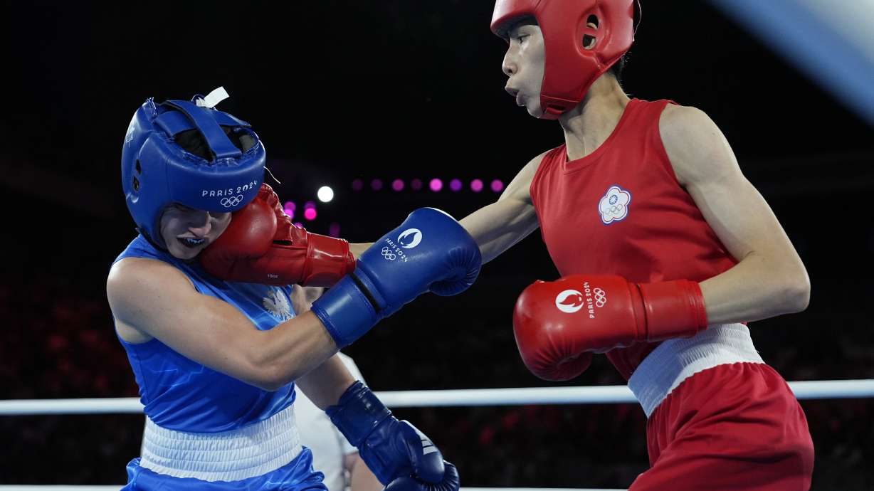 Taiwan's Lin Yu-ting, right, fights Poland's Julia Szeremeta in their women's 57 kg final boxing match at the 2024 Summer Olympics, Saturday, Aug. 10, 2024, in Paris, France.