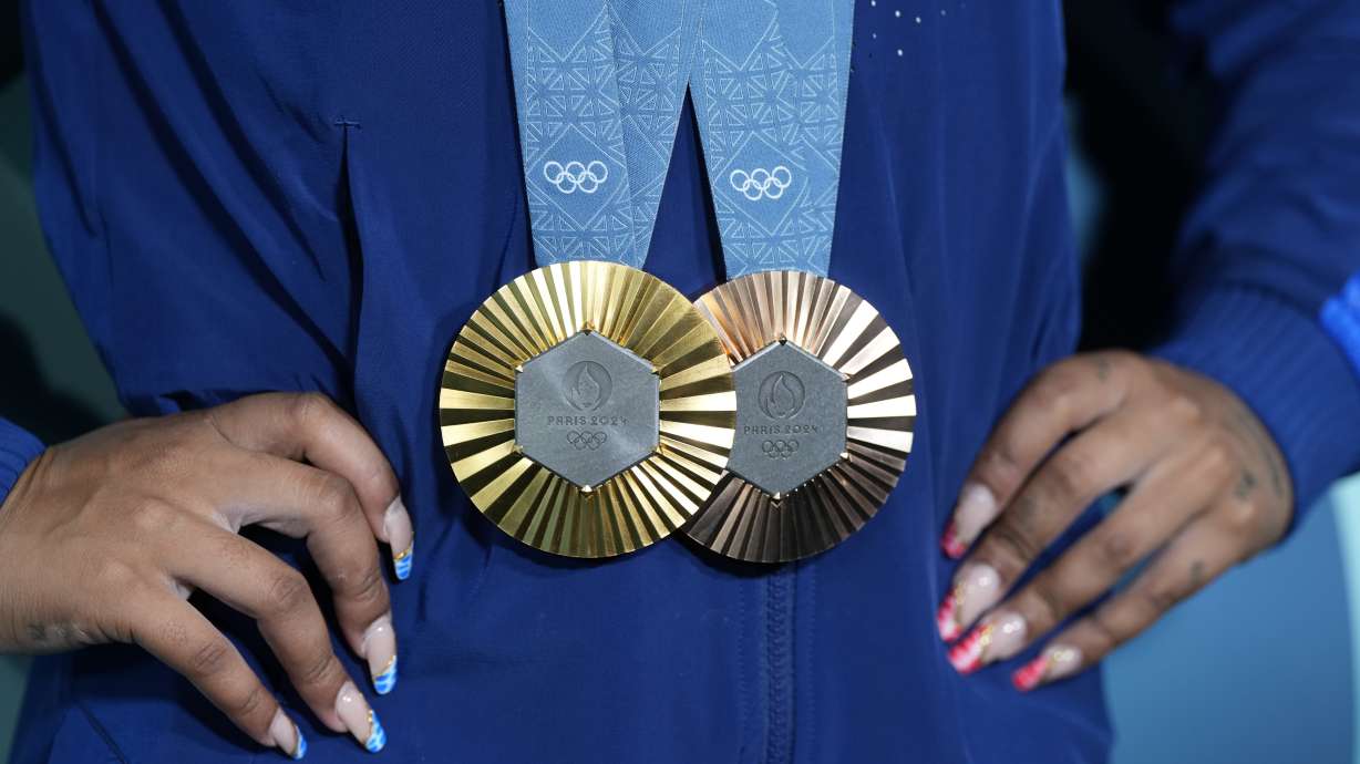 Jordan Chiles, of the United States, holds up her medals after the women's artistic gymnastics individual apparatus finals Bercy Arena at the 2024 Summer Olympics, Monday, Aug. 5, 2024, in Paris, France.