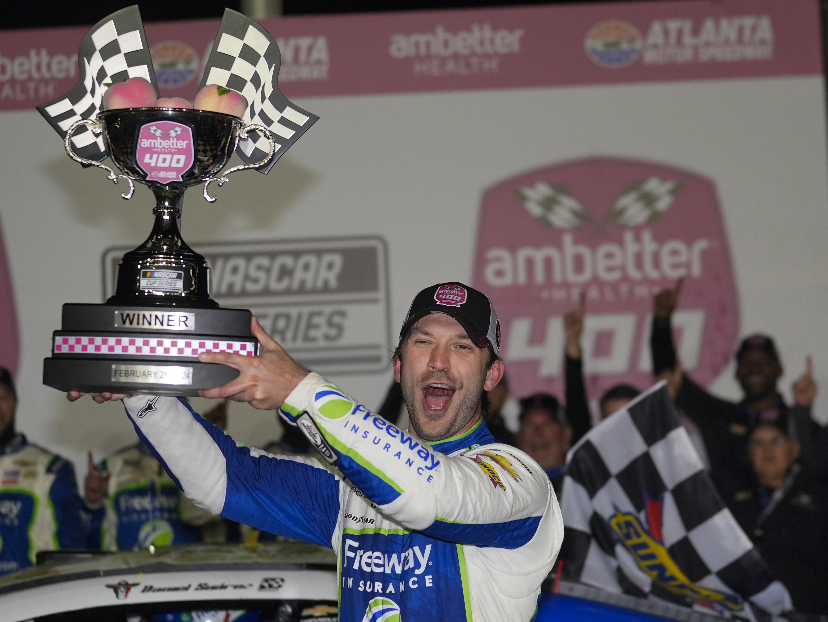 FILE - Daniel Suarez holds the trophy after winning the NASCAR auto race at Atlanta Motor Speedway Sunday, Feb. 25, 2024, in Hampton , Ga. NASCAR Cup Series driver Daniel Suarez will compete next month in the sanctioning body's Brasil Series Special Edition tournament that runs parallel to its main competition in Brazil.