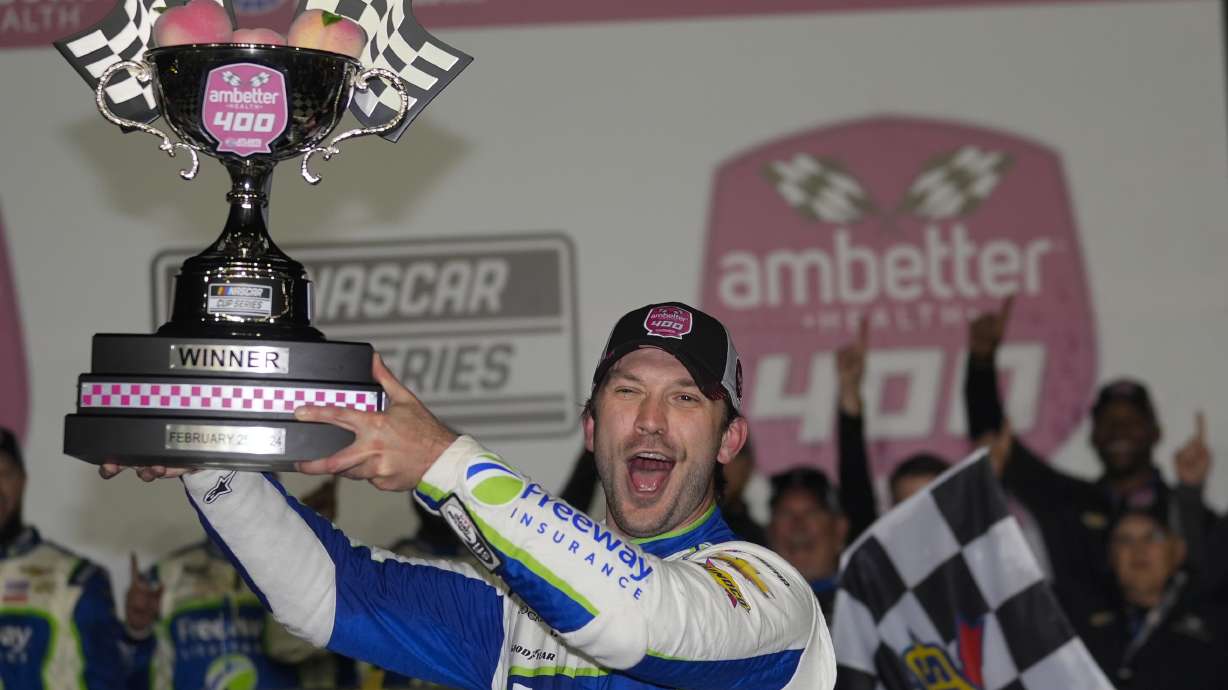 FILE - Daniel Suarez holds the trophy after winning the NASCAR auto race at Atlanta Motor Speedway Sunday, Feb. 25, 2024, in Hampton , Ga. NASCAR Cup Series driver Daniel Suarez will compete next month in the sanctioning body's Brasil Series Special Edition tournament that runs parallel to its main competition in Brazil.